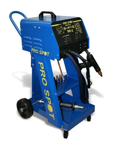 Blue metal welding machine with controls, hoses, and wheels.