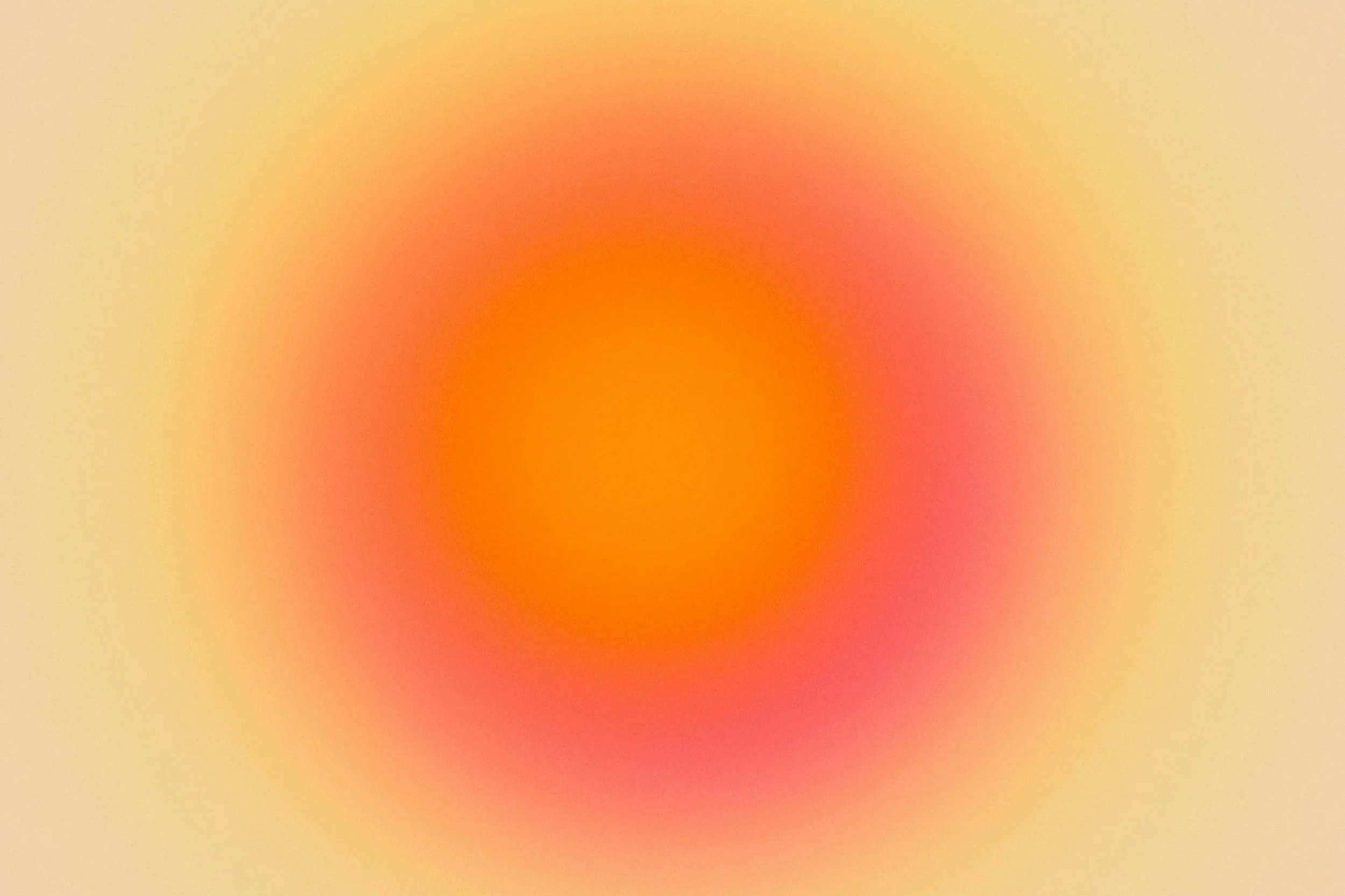 Blurred gradient with warm colors transitioning from light yellow to red and orange.