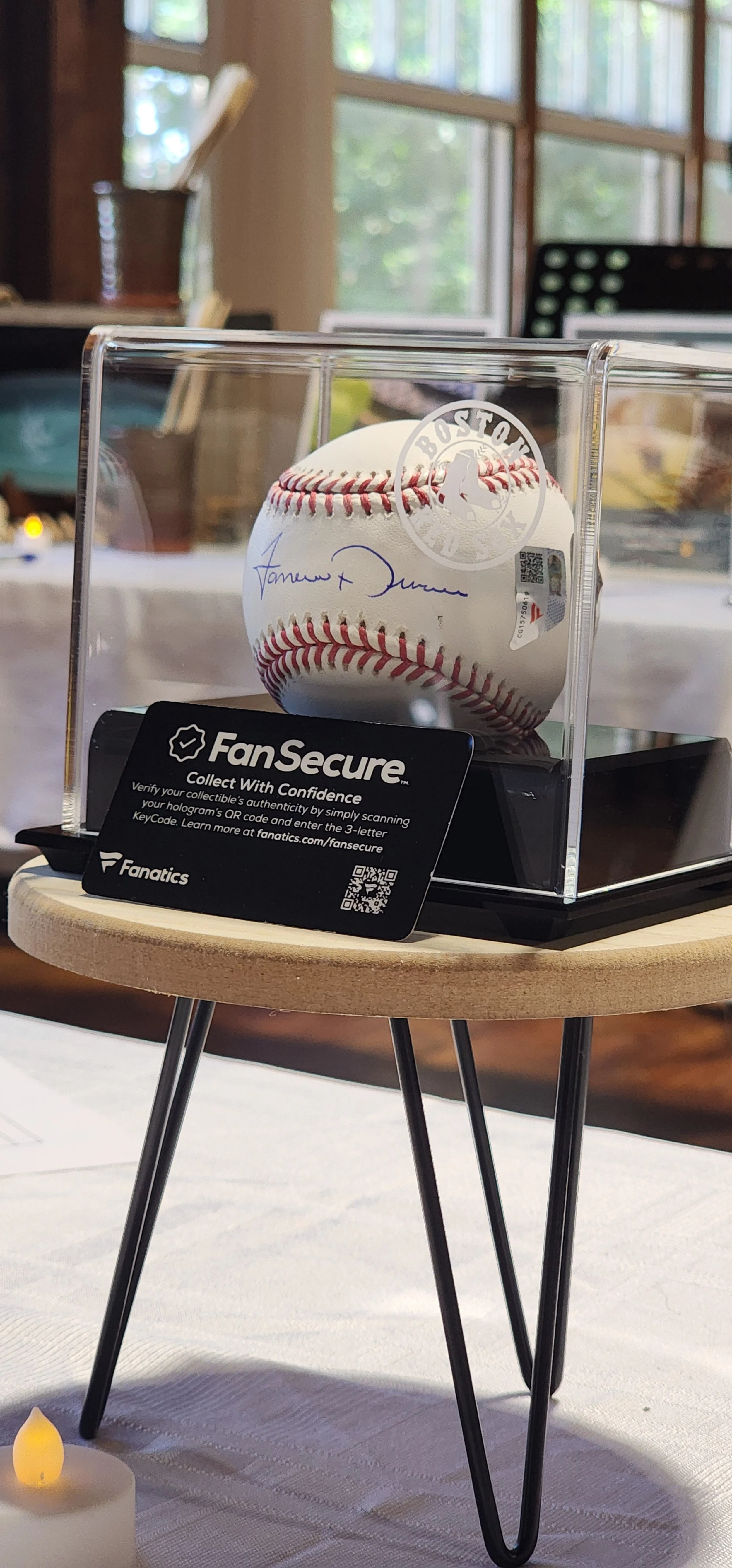 A signed baseball in a glass care