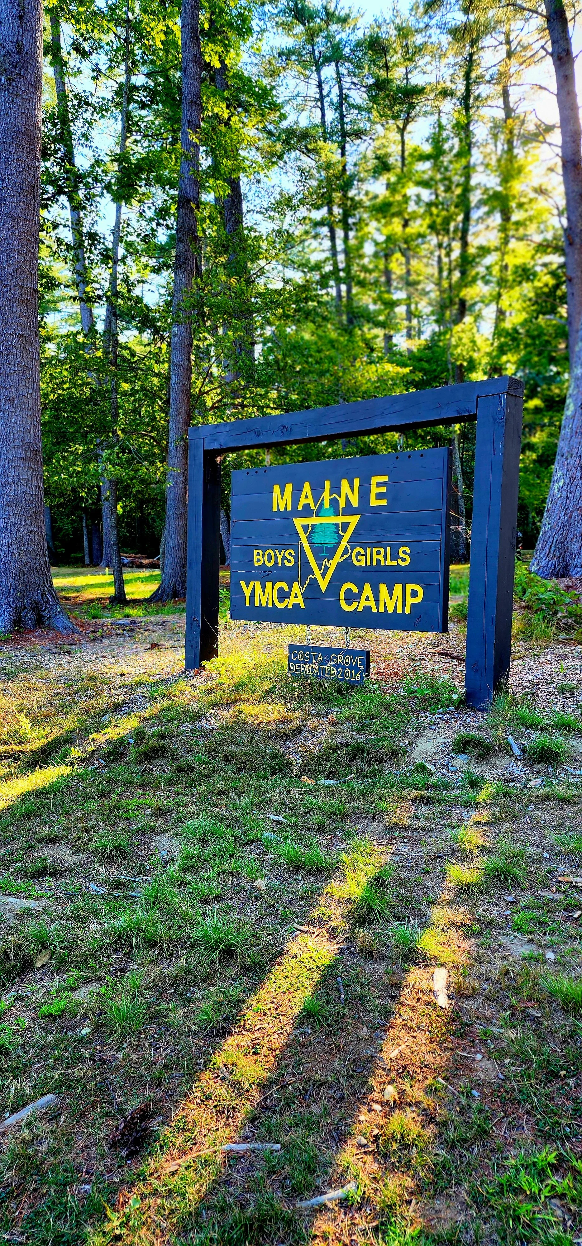 A wooden sign saying, "Maine YMCA Camp"
