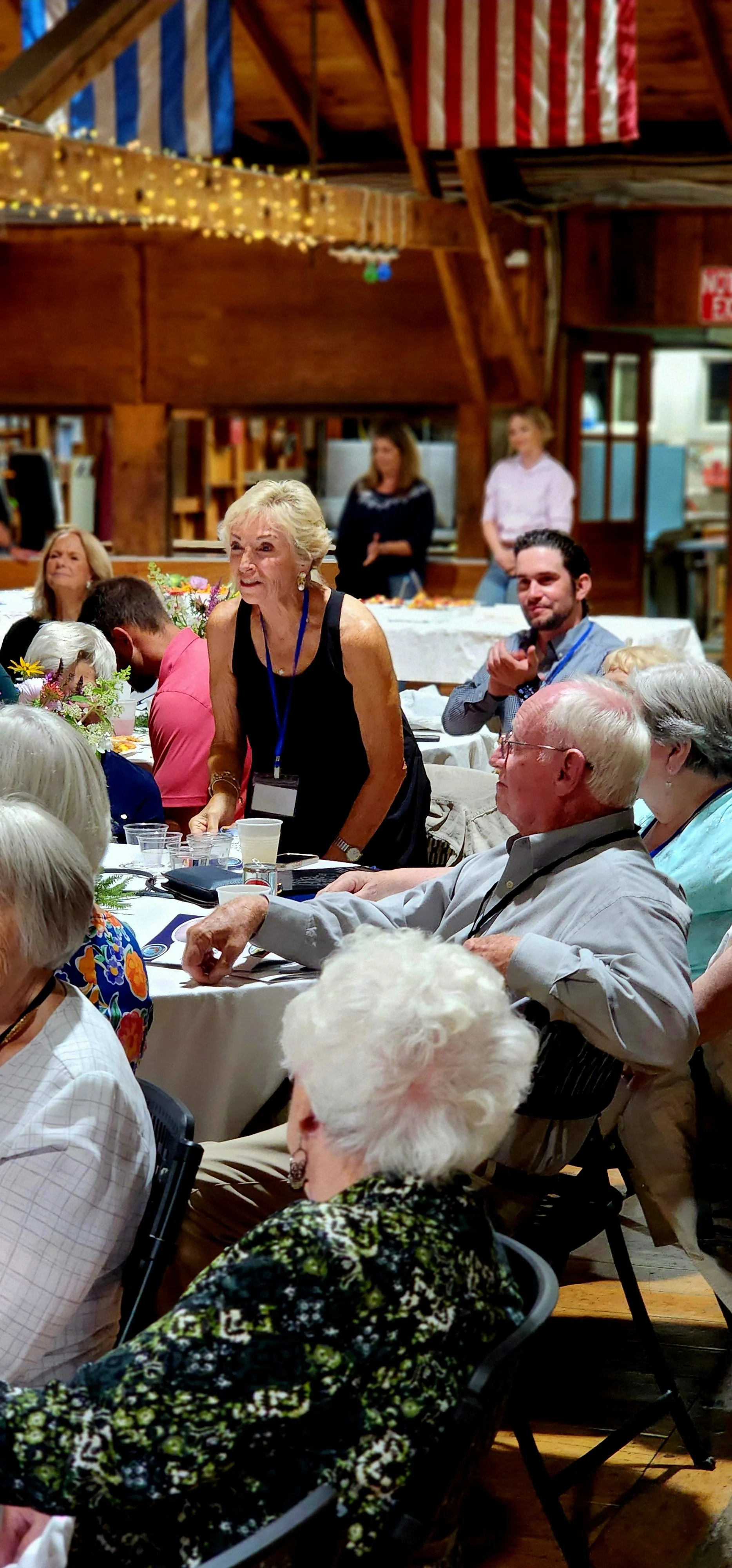 People sitting at tables watching something off camera