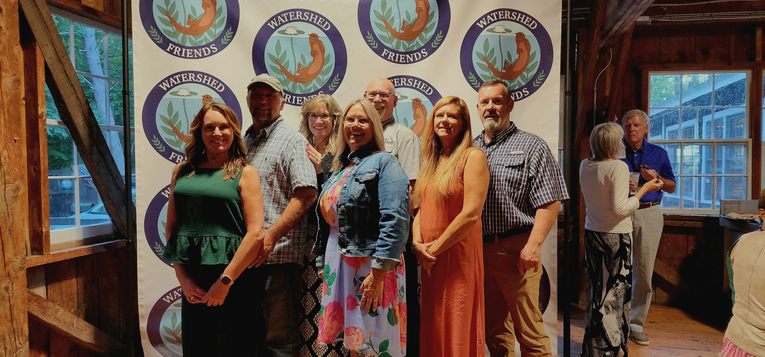 Three men and five women, lined up smiling at the camera