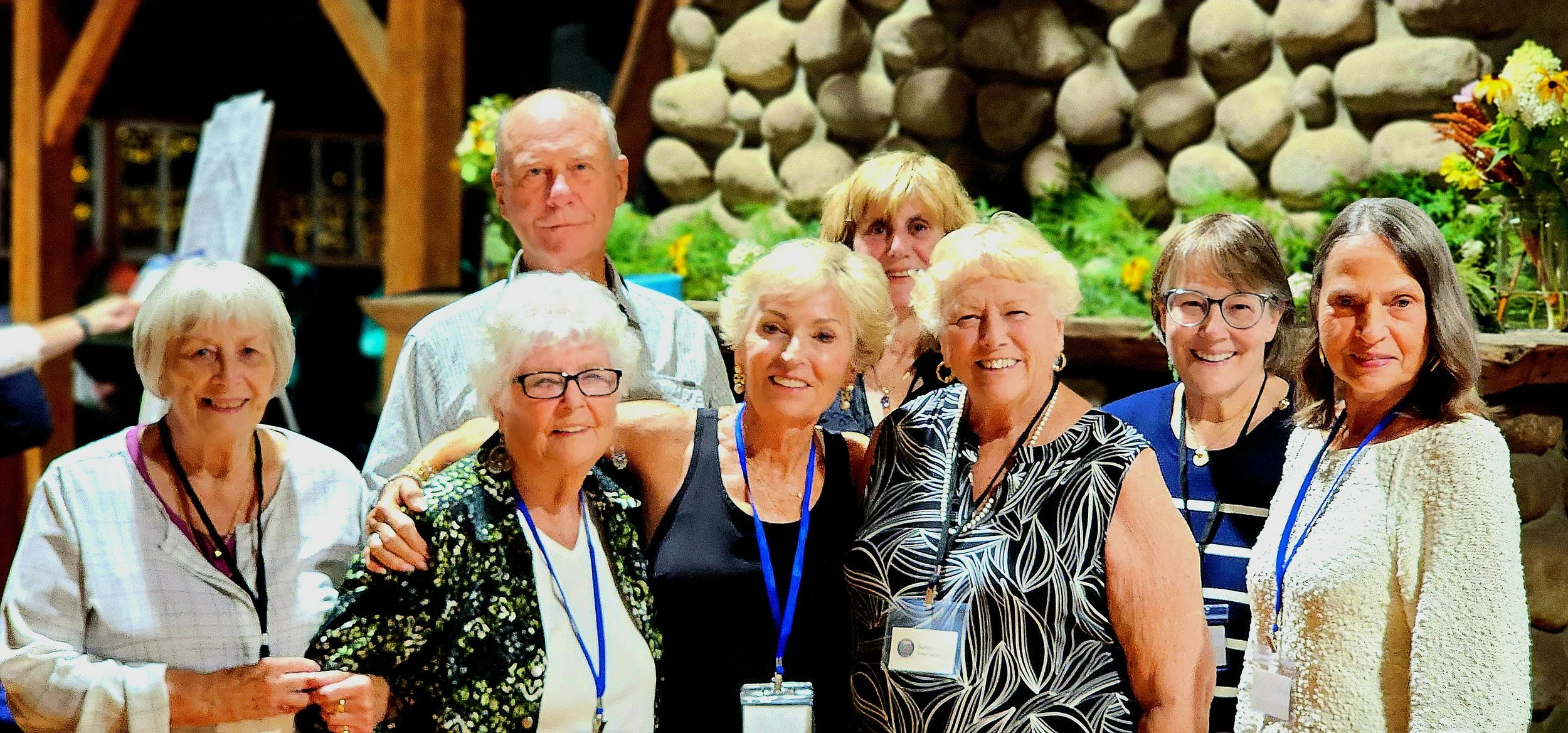 Eight people lined up, smiling at the camera