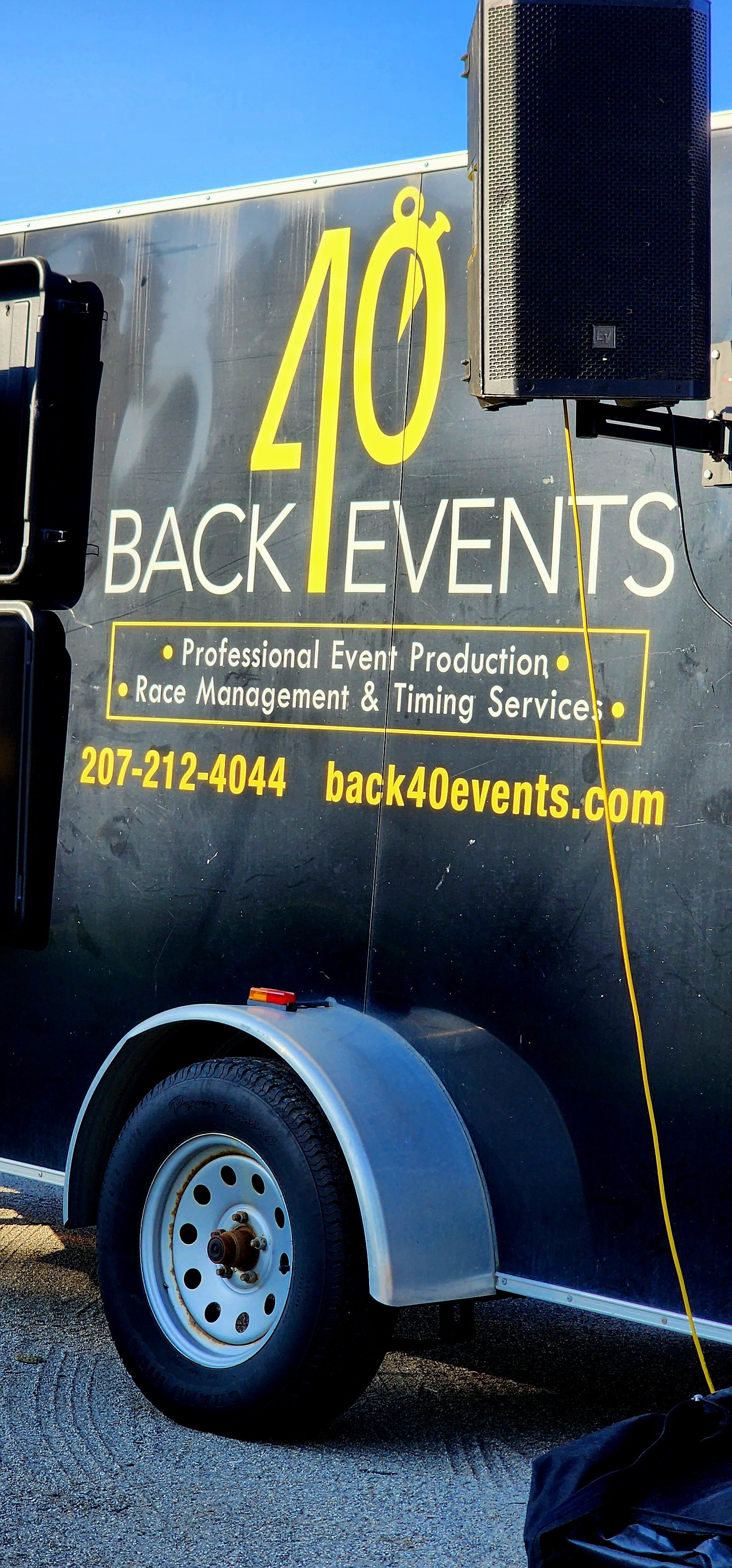 A cargo trailer with the Back 40 Events logo