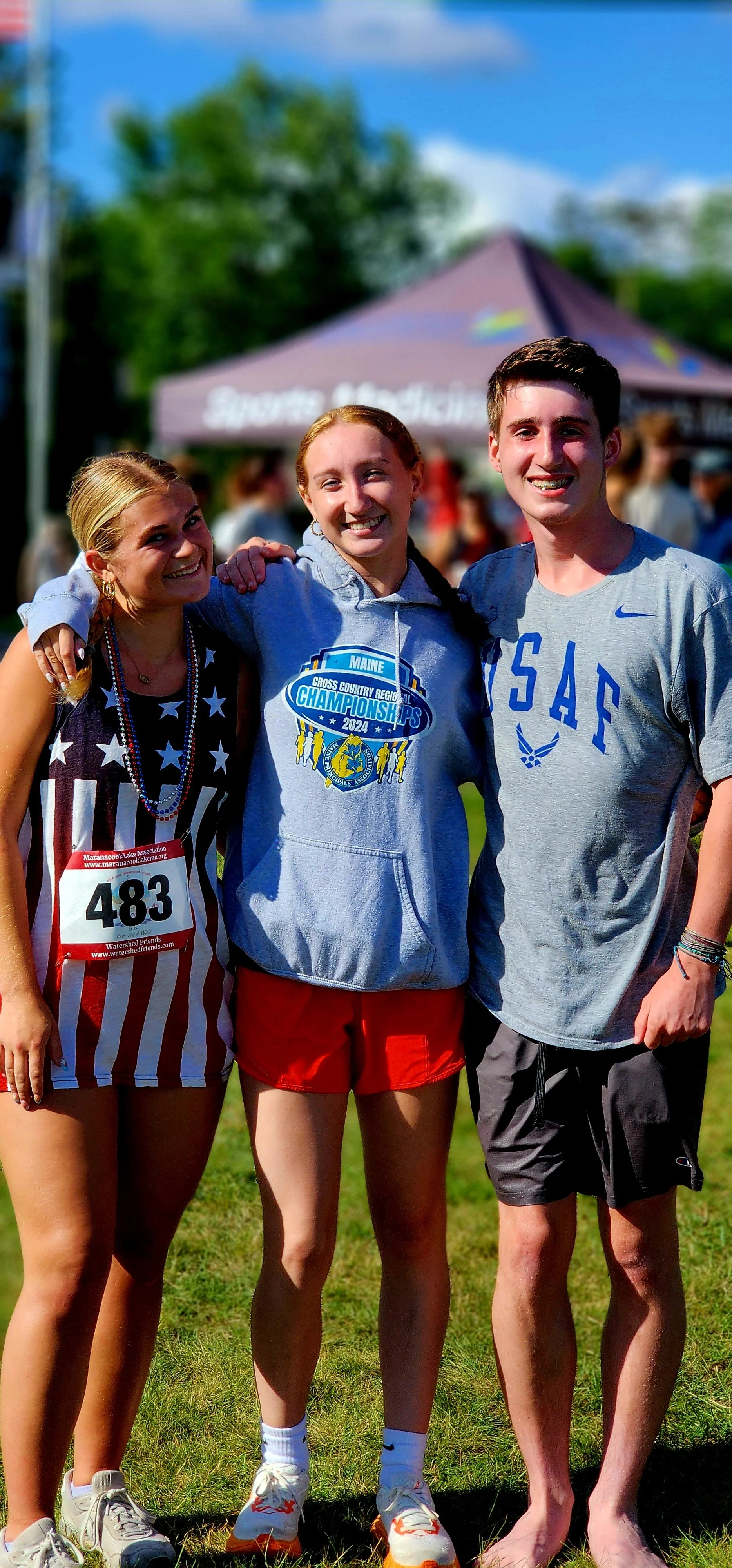 Three people smiling at the camera