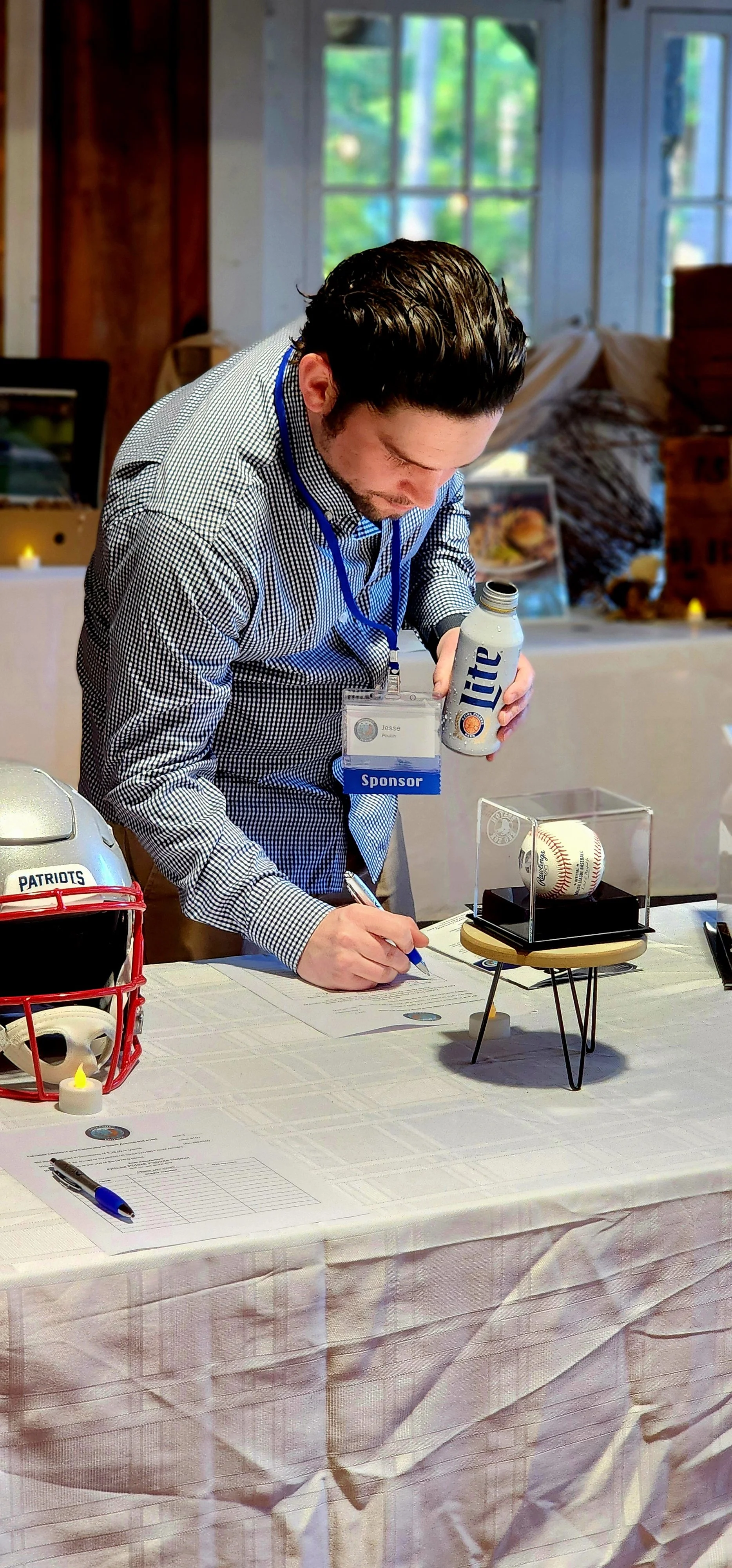 Man making a bid on a silent auction item