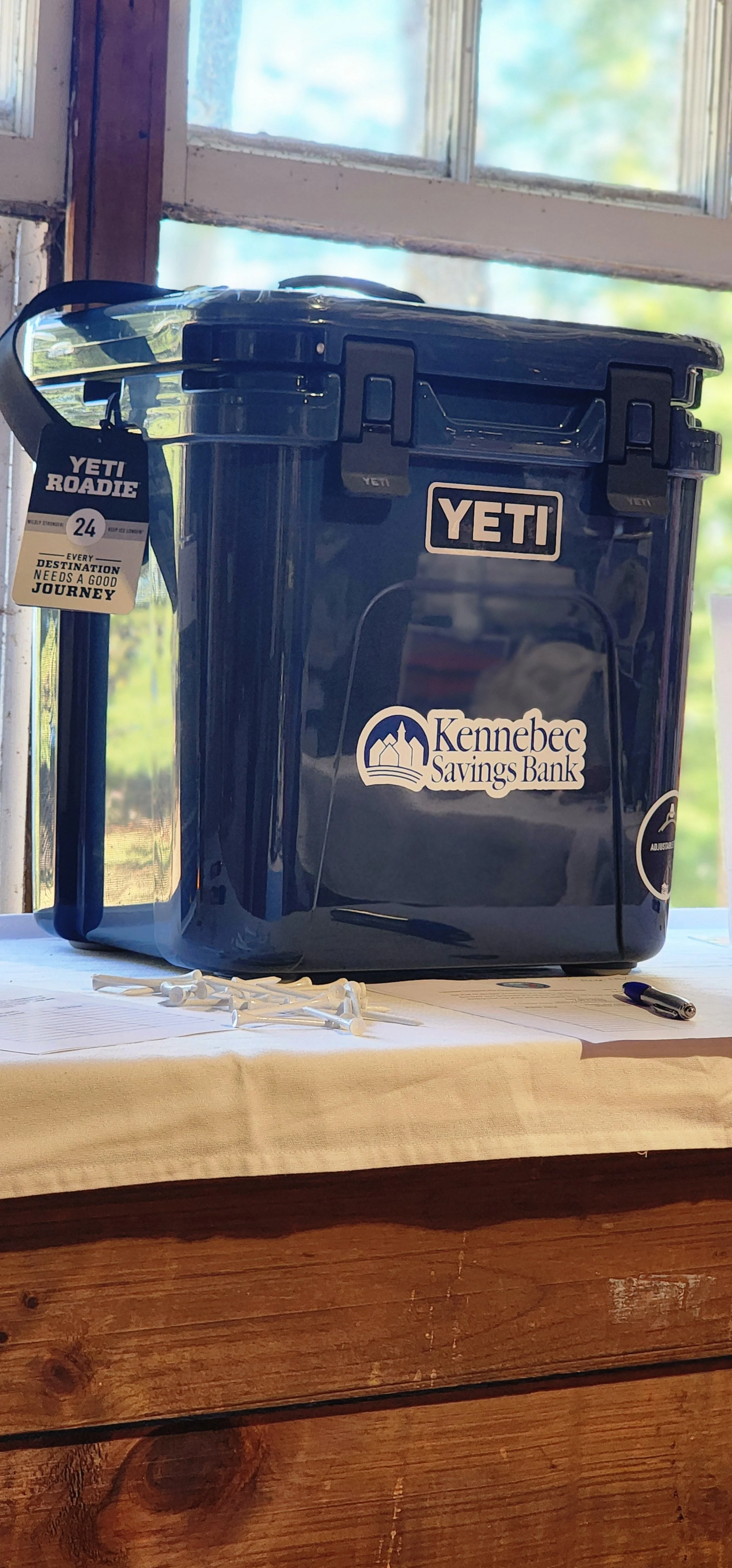 A blue yeti cooler with a Kennebec Savings Bank logo sticker