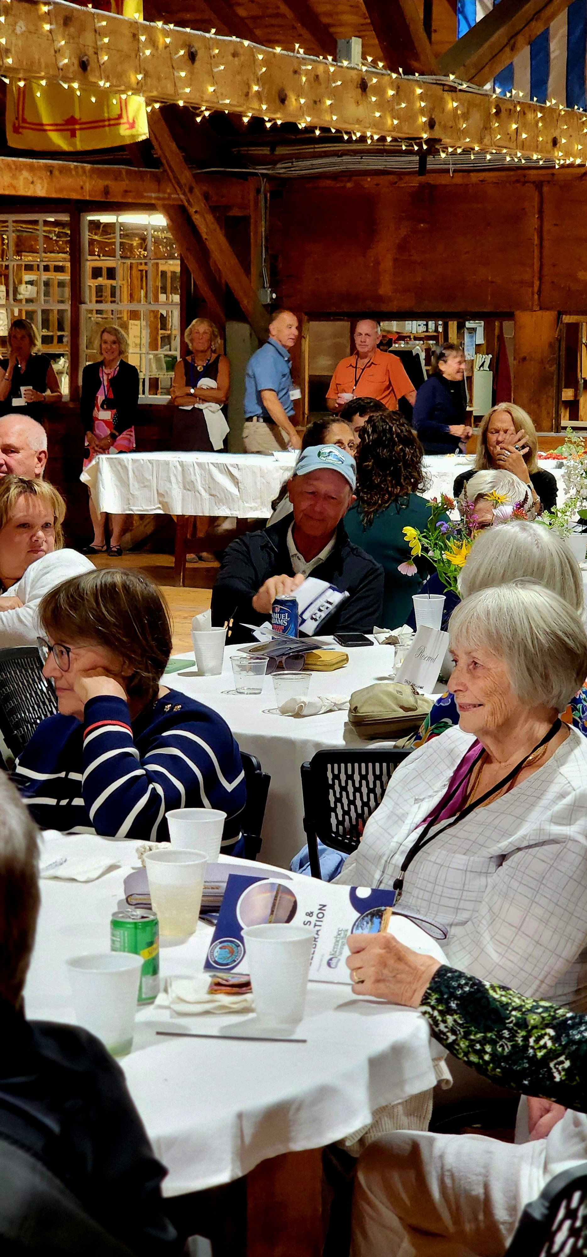 People sitting at tables watching something off camera