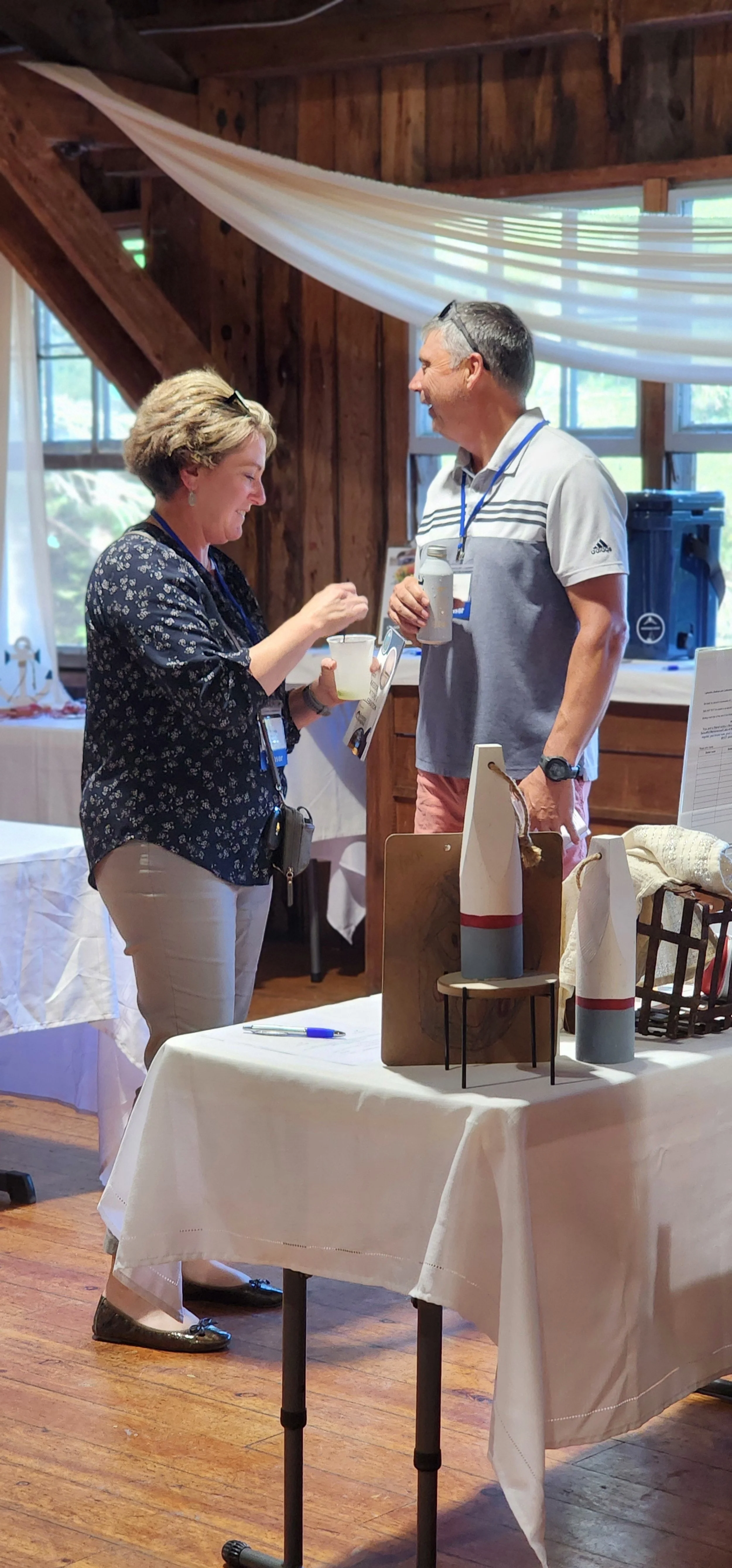 Two people looking at silent auction items