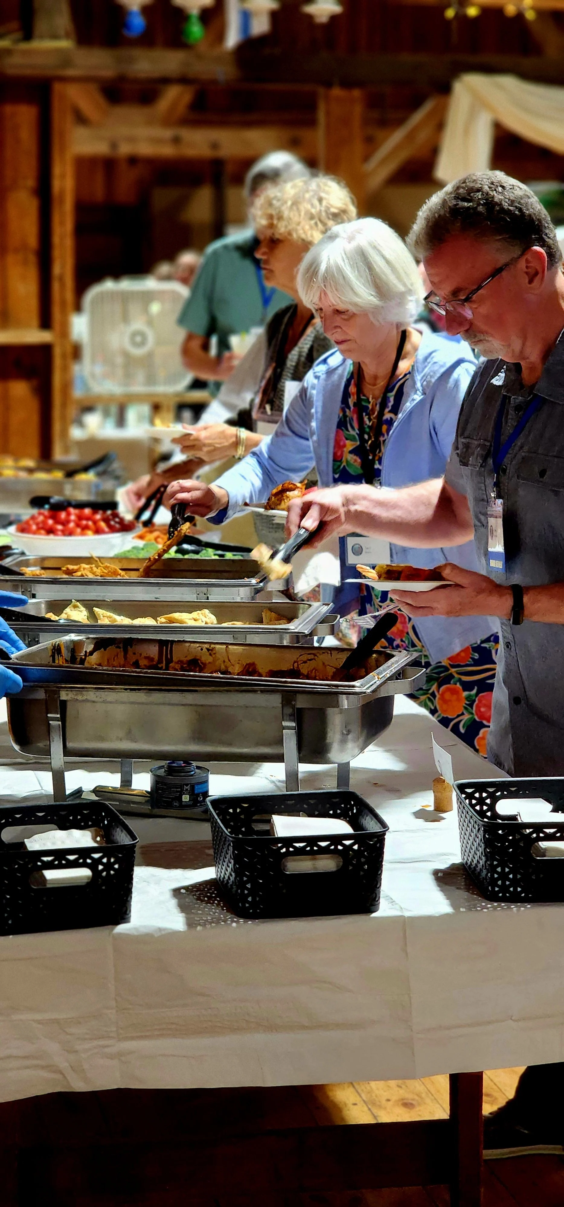 People selecting food from the buffet