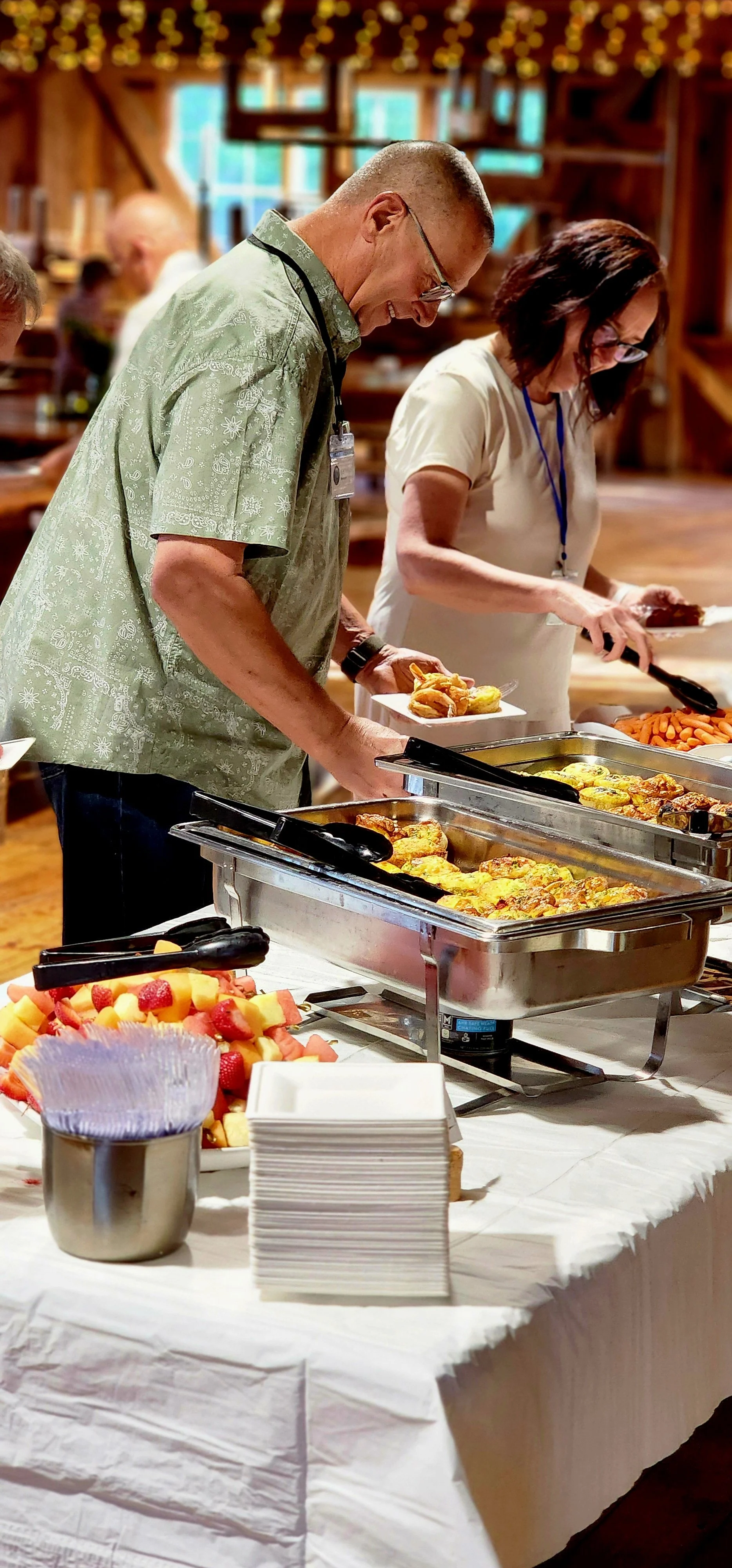 People taking food from a buffet table