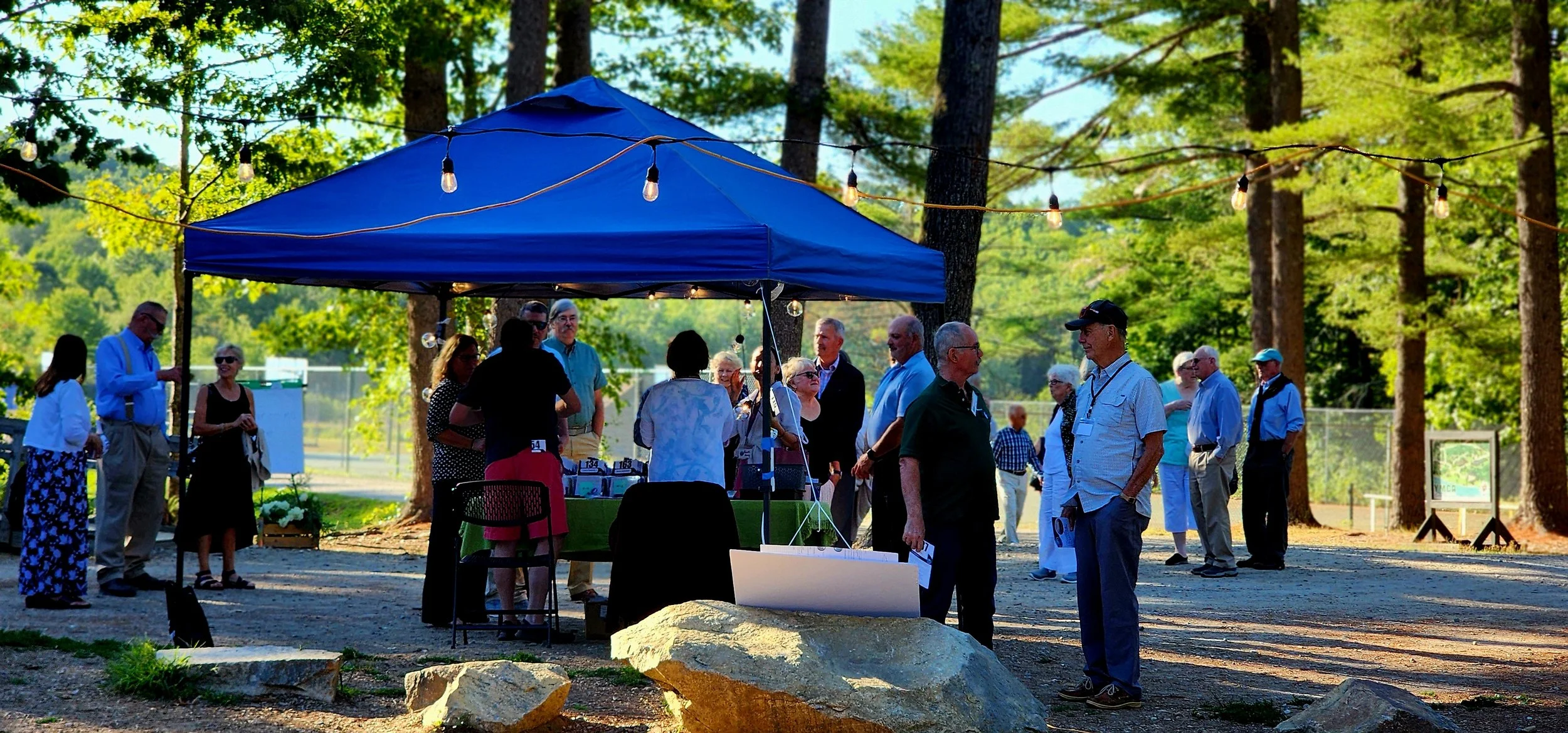 People gathering around a registration tent