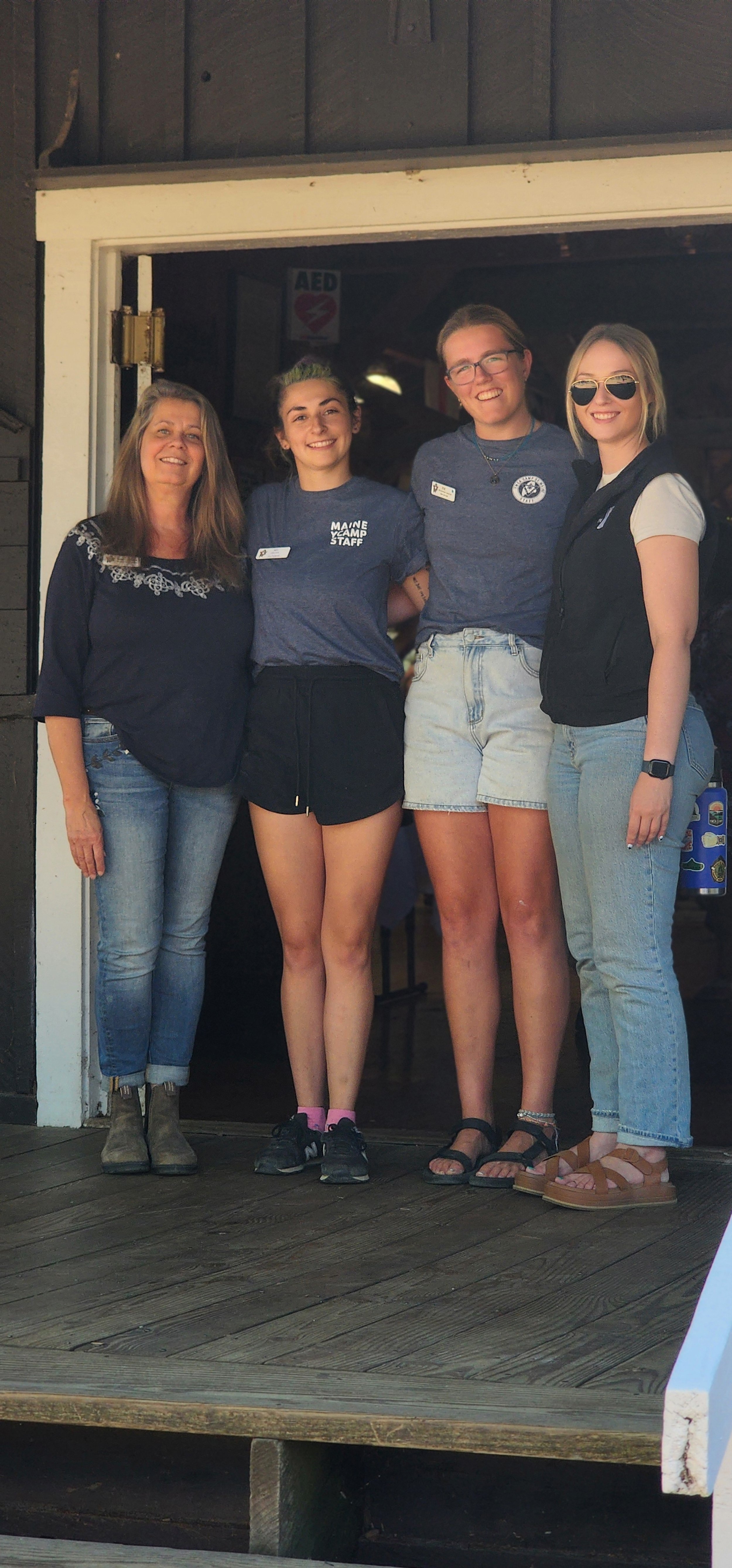 A group of four people standing in front of a a doorway