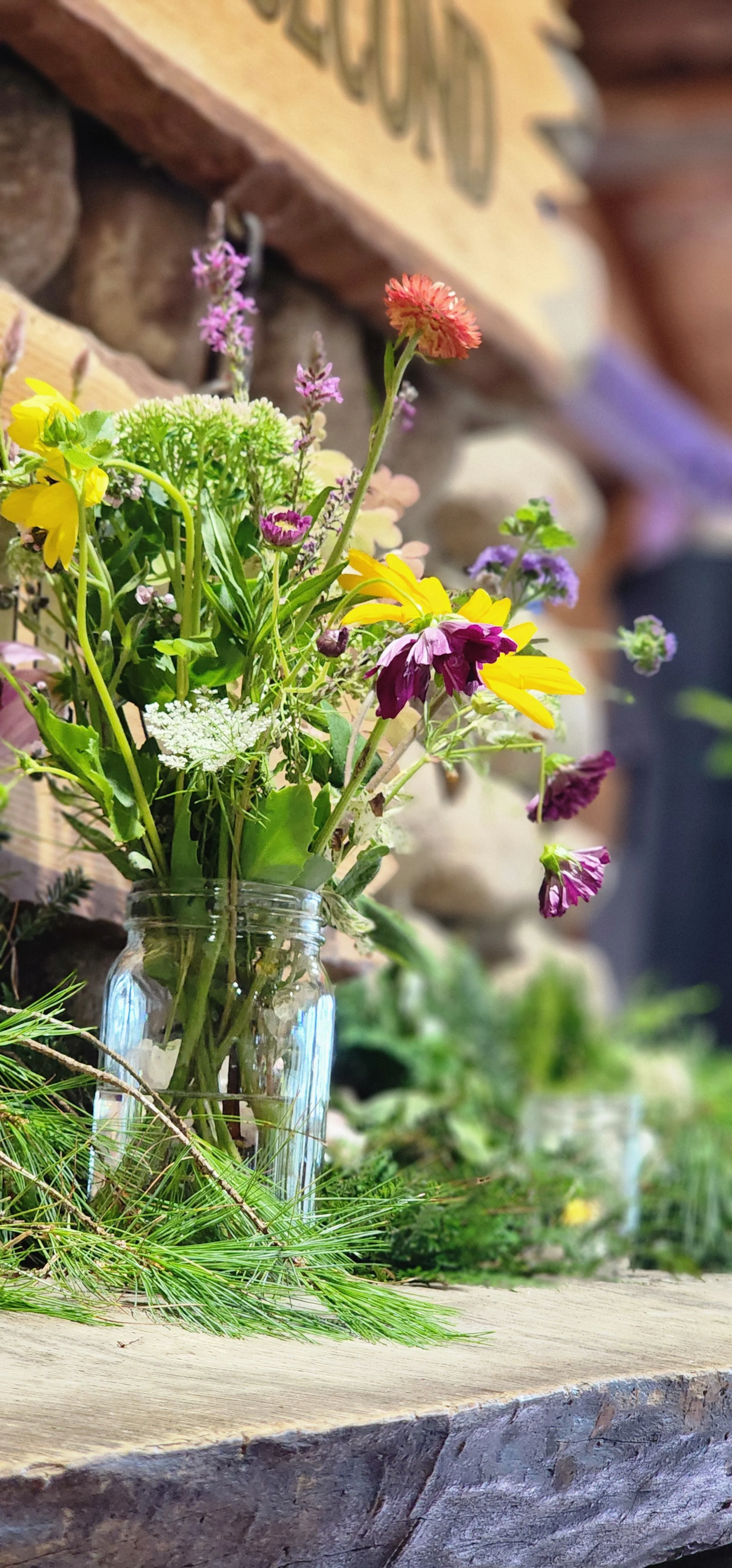 A vase of flowers sitting on a fireplace mantle