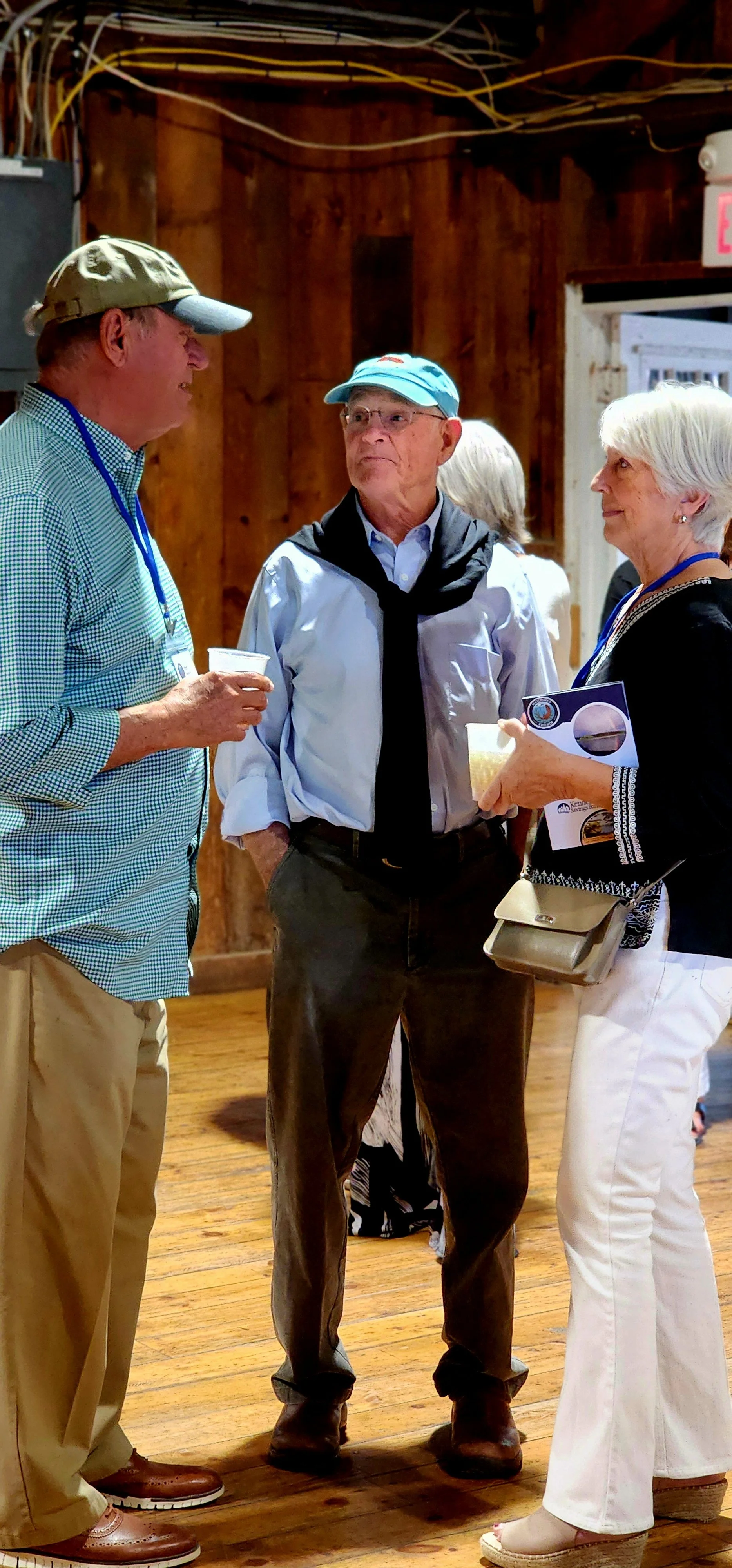 Three people facing each other, talking