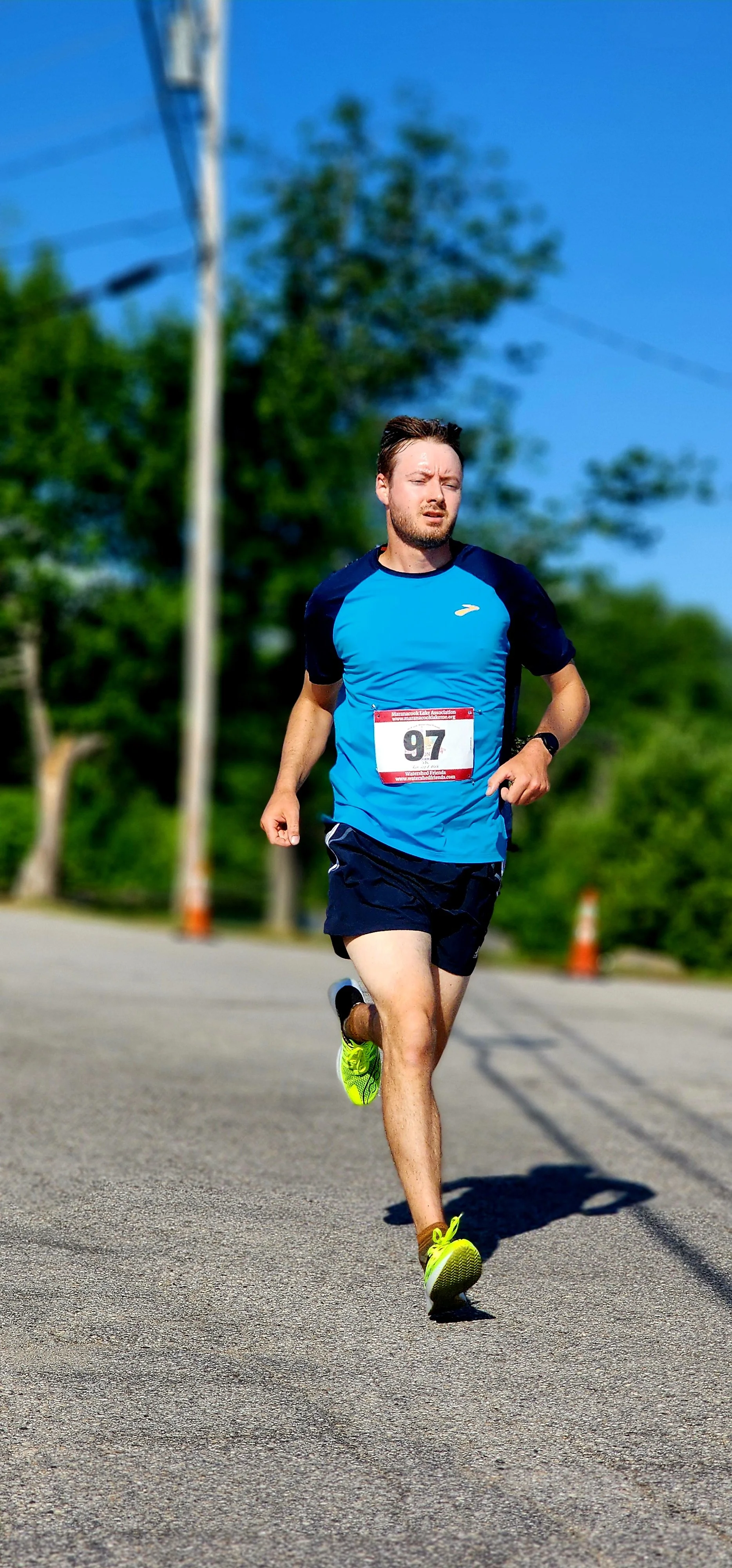 A man in a blue t-shirt and black shorts running
