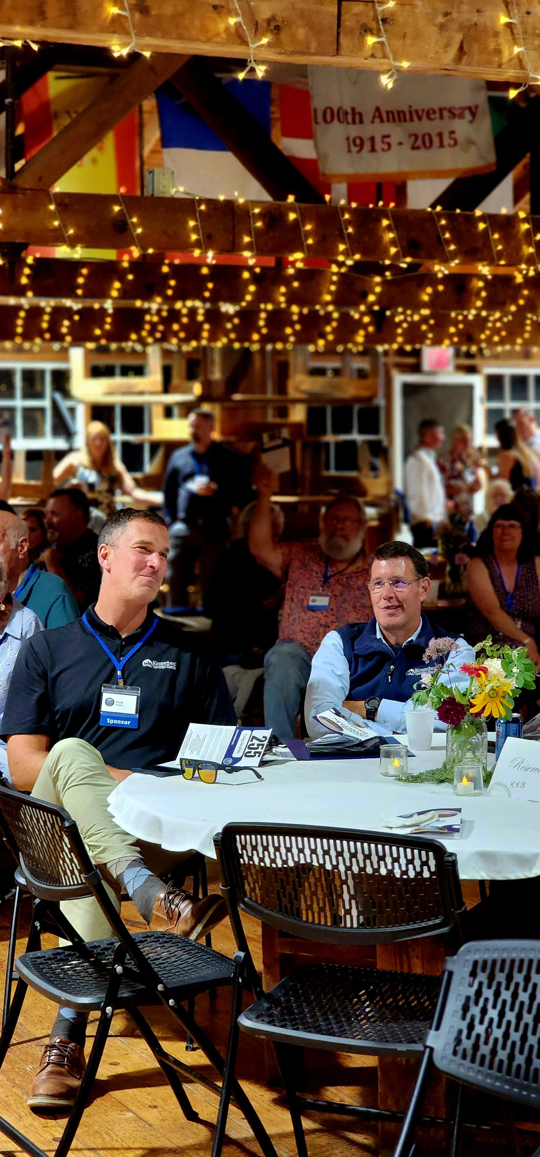 People sitting at a table watching something off camera