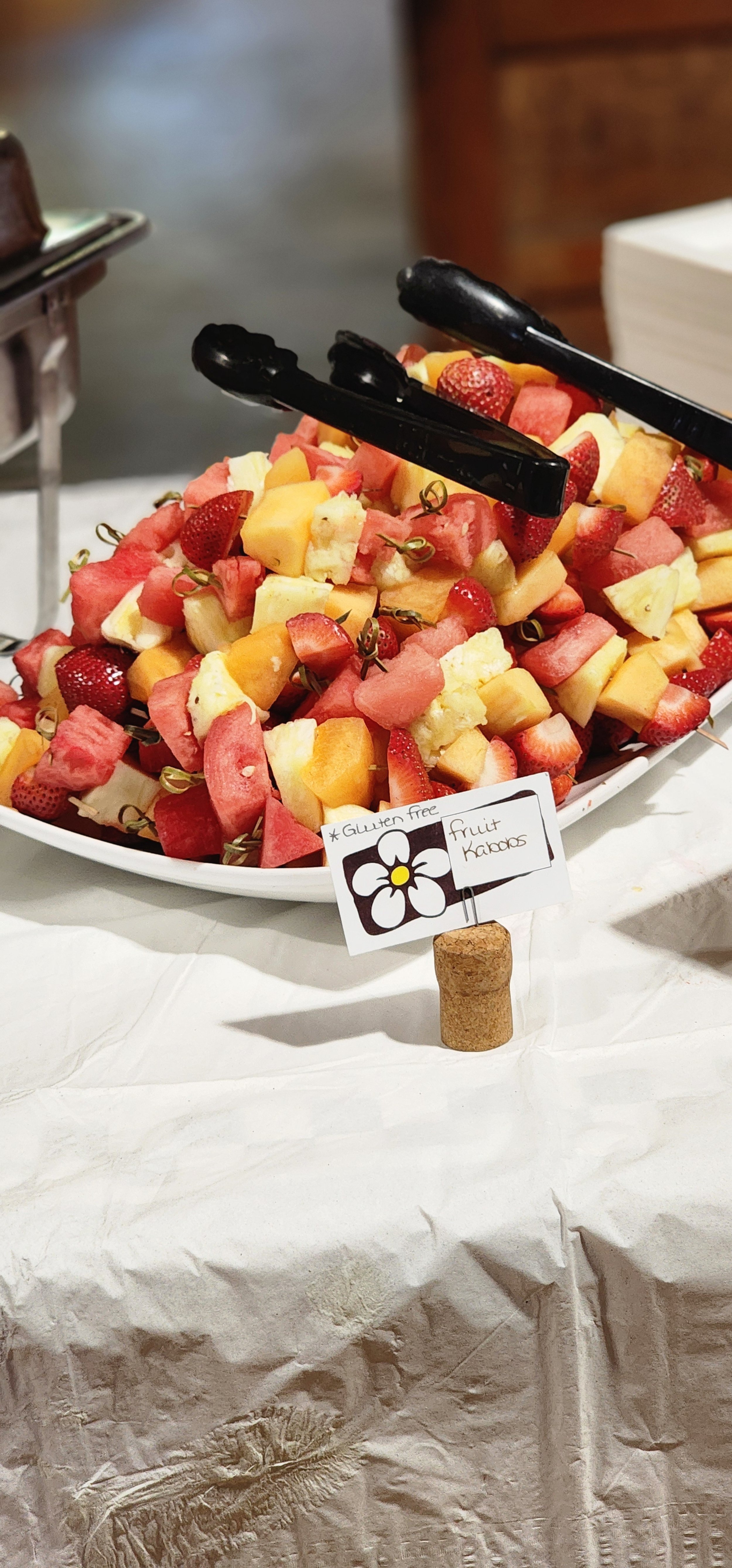 A bowl of fruit skewers 