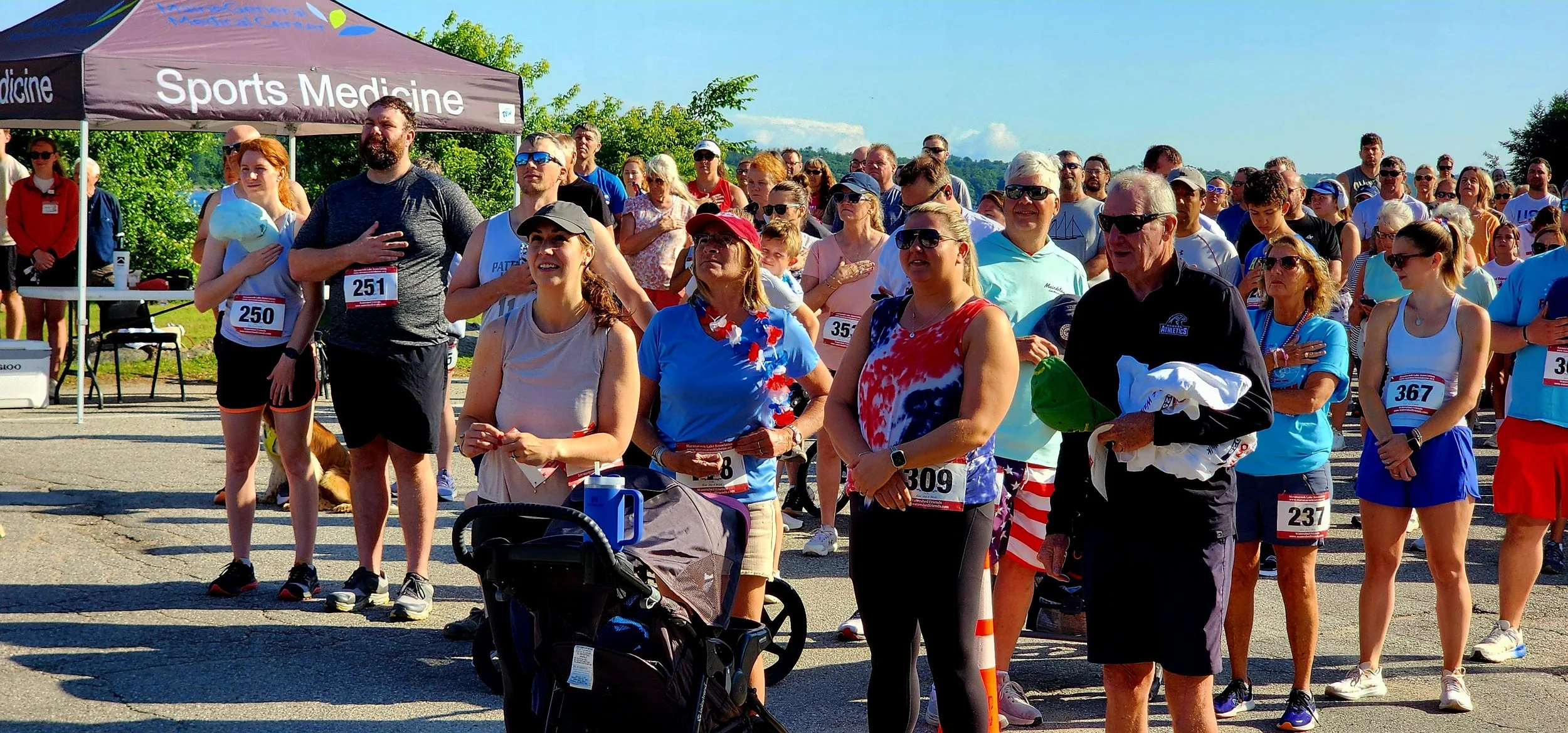 A crowd standing for the national anthem
