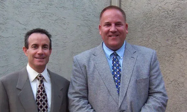 Two men, Jay Snider and Bob Moore, posed smiling at the camera