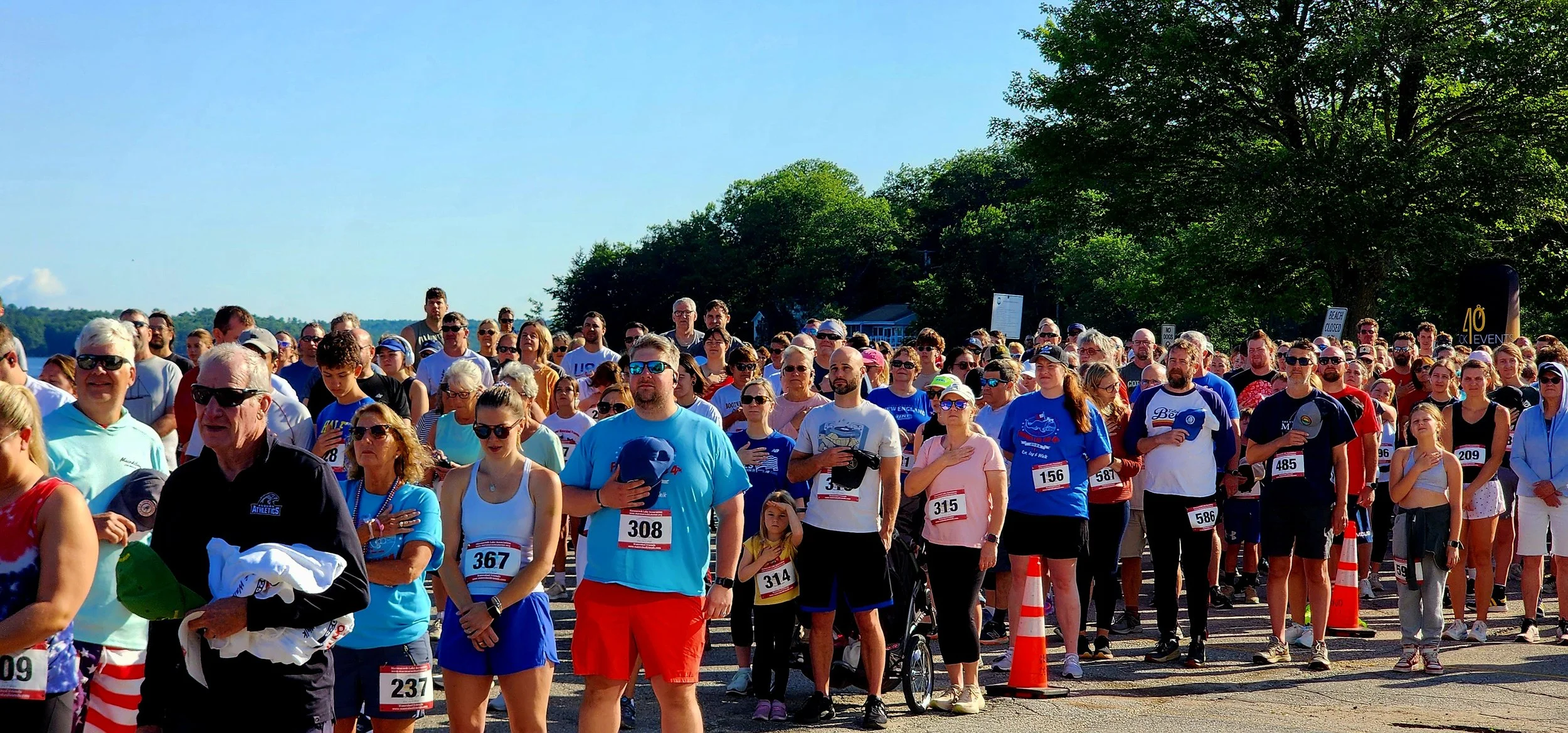 A crowd standing for the national anthem