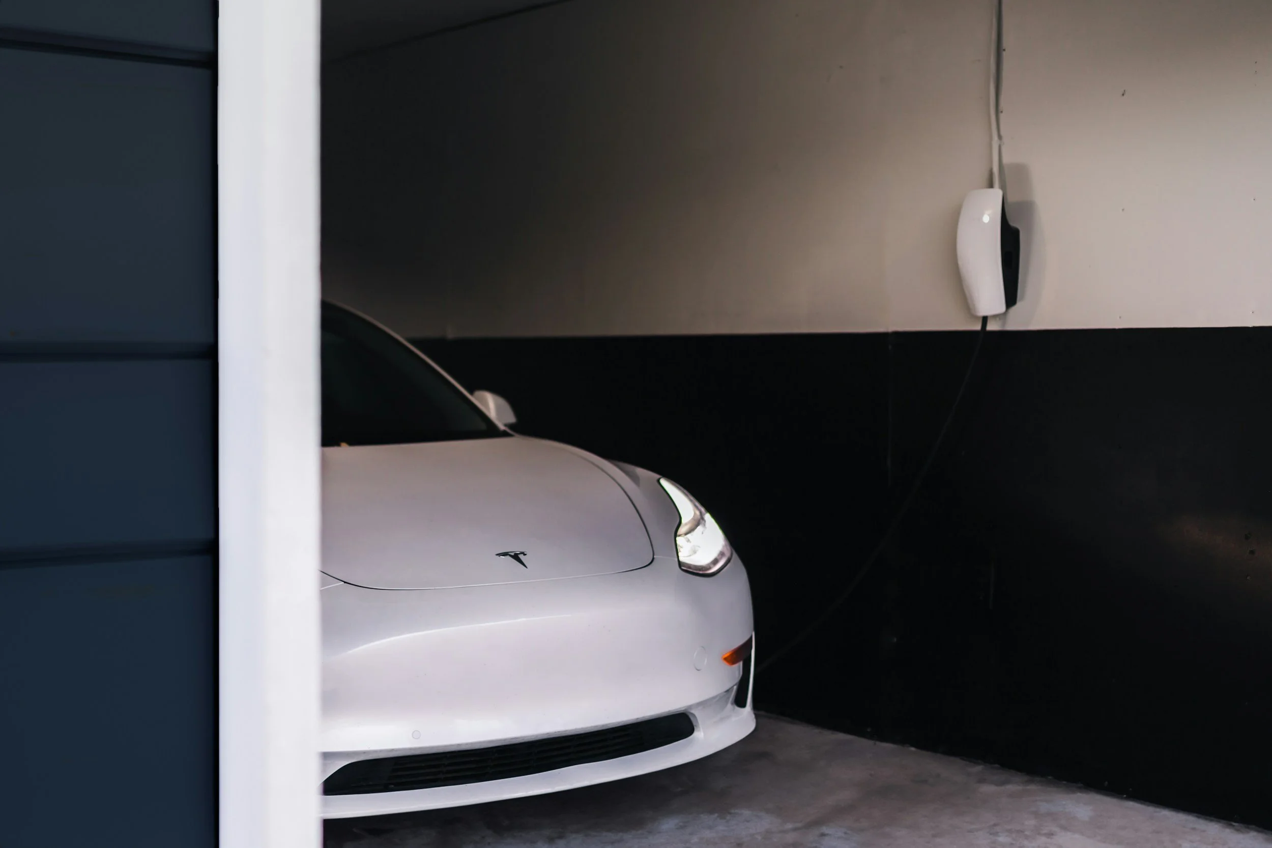 Tesla electric car charging in a garage