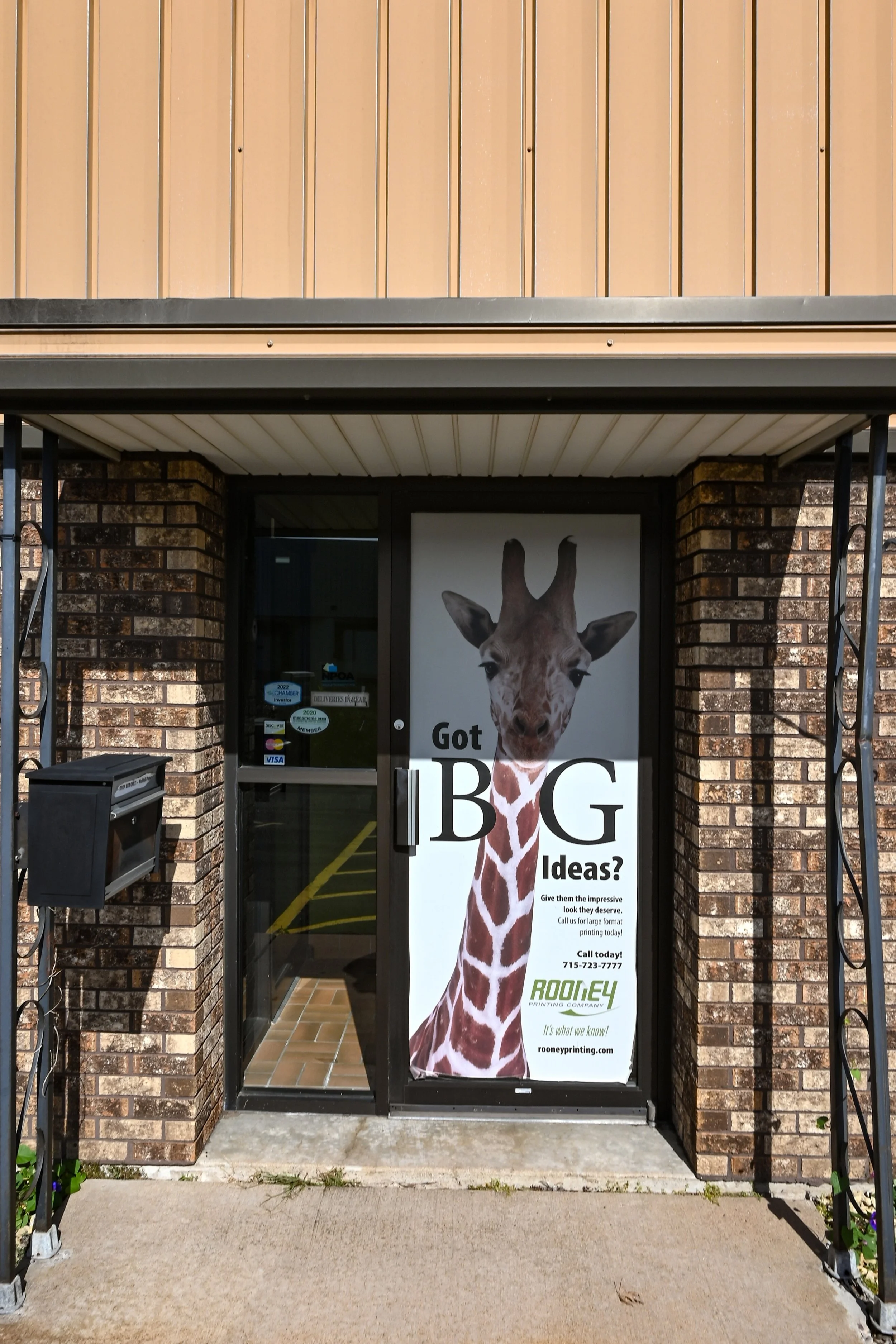 Front door of Rooney Printing with promotional banner signage