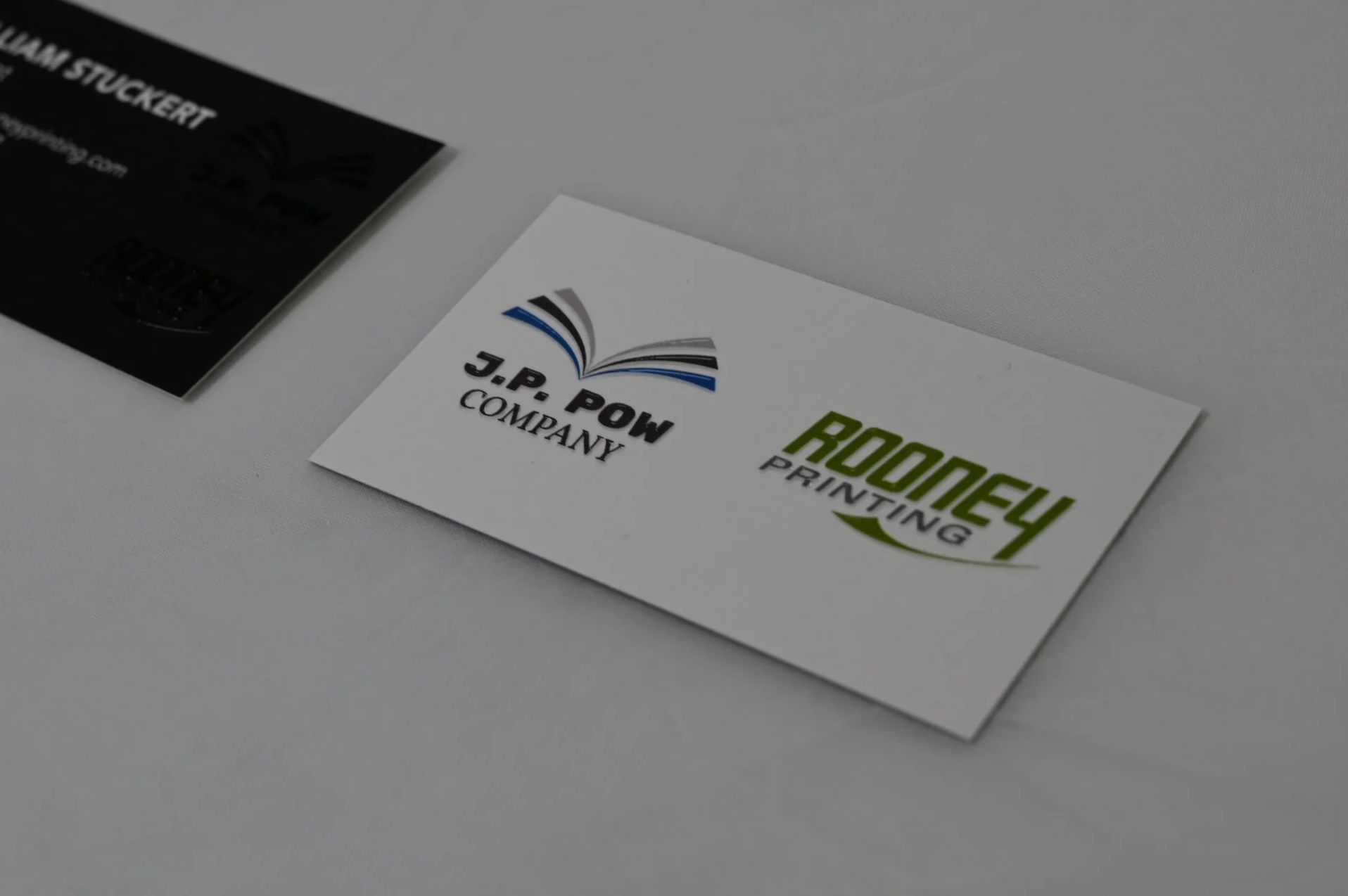Business cards on a table, printed with customer logos