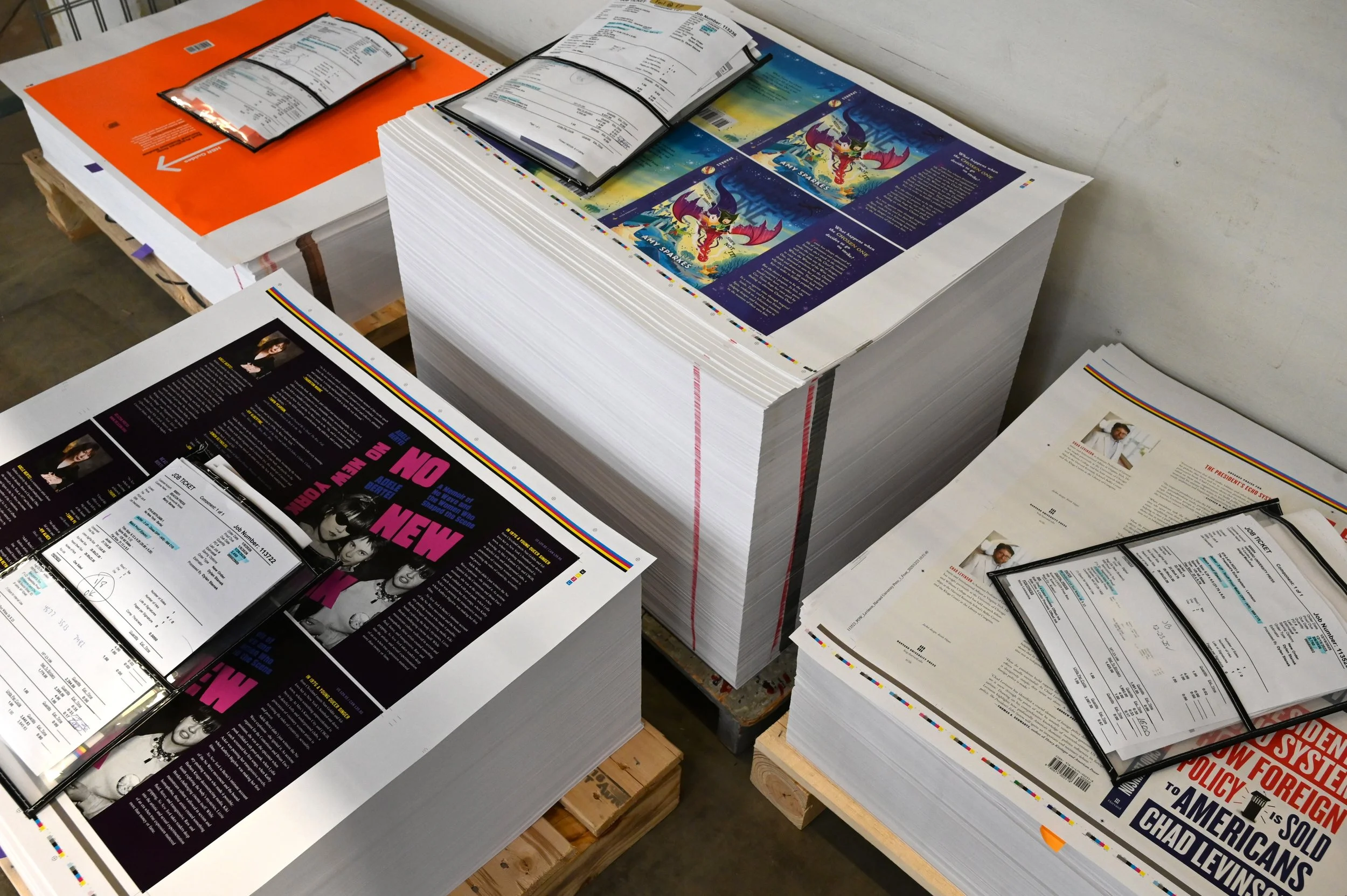 Stacks of printed book covers ready for trimming and finishing