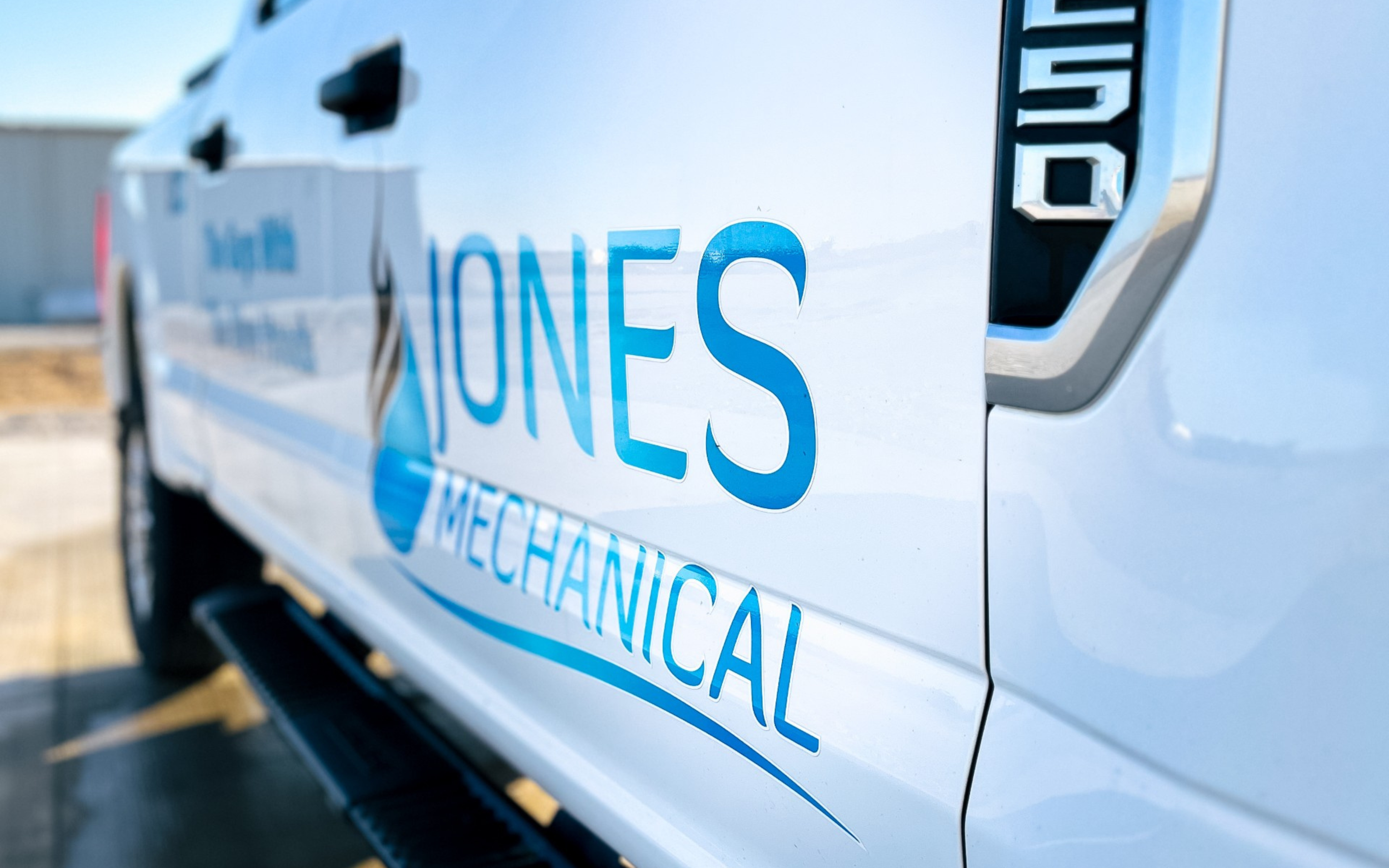 Side view of Jones Mechanical hvac contracting van in Southwest Iowa parking lot.