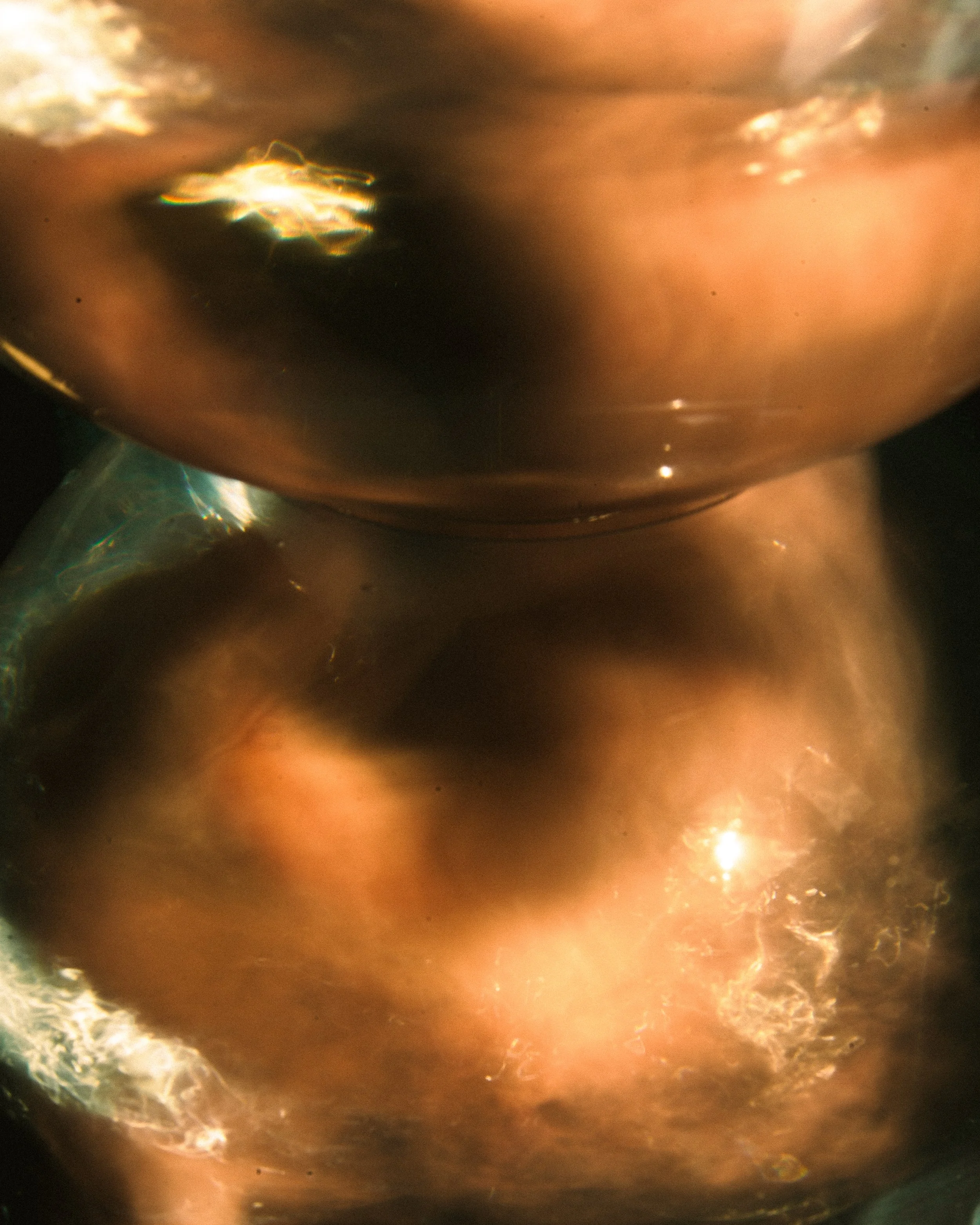 Close-up of two copper-colored, reflective objects with a blurred, abstract background.