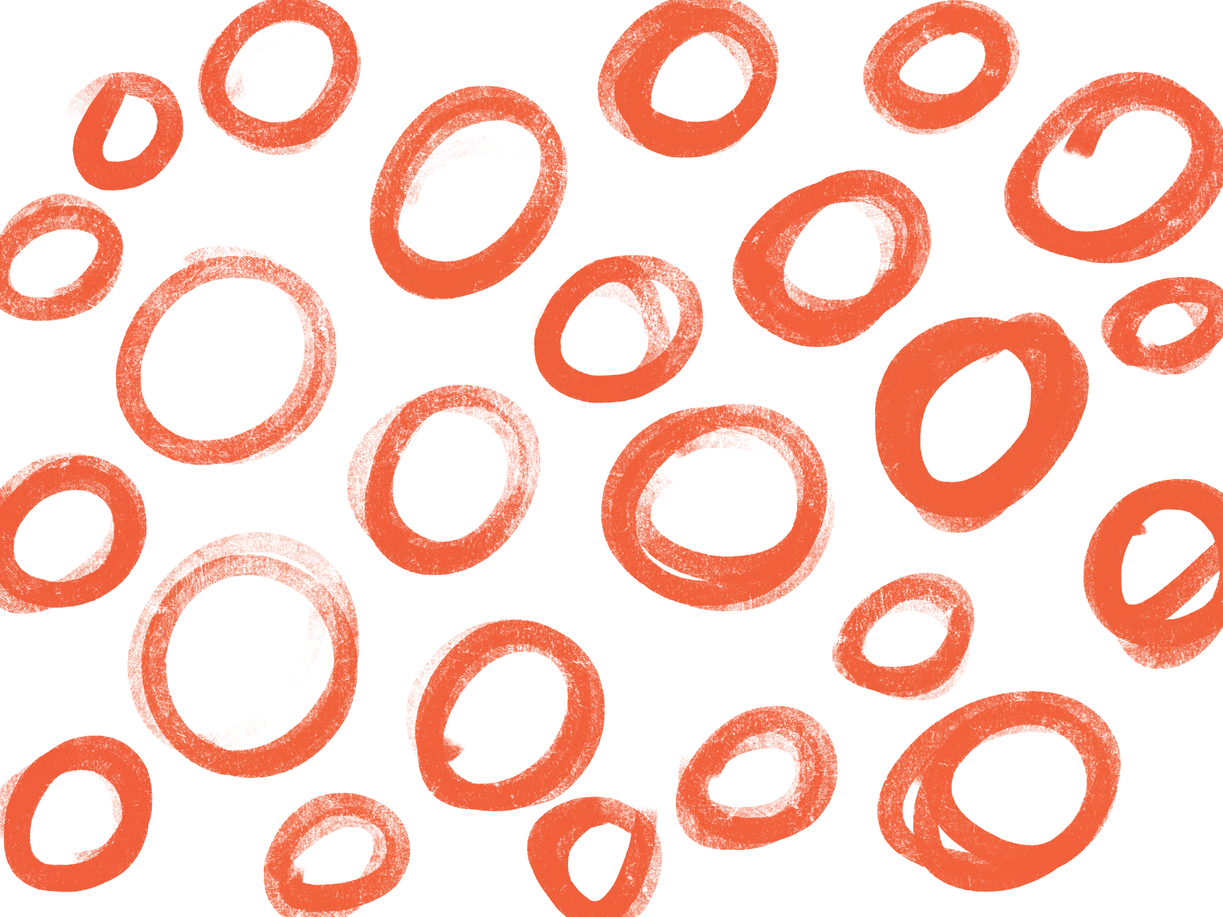 Multiple orange rubber O-rings scattered on a black background.