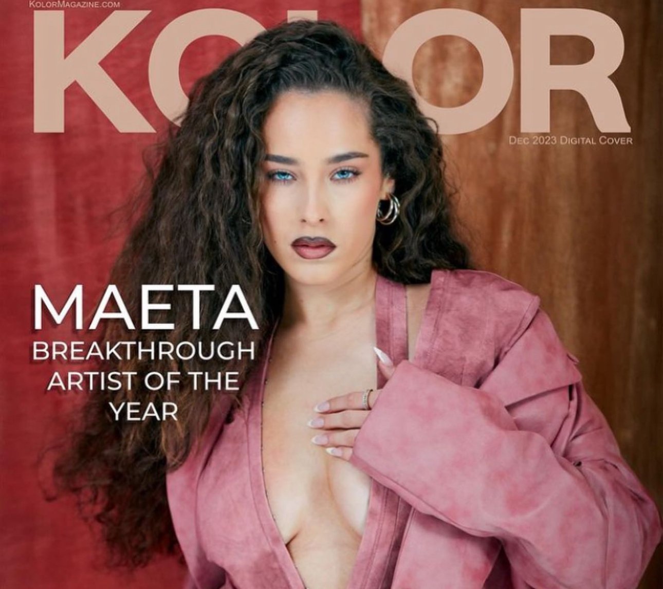 Magazine cover featuring a woman with curly hair, blue eyes, and dark lipstick, wearing a pink jacket with a deep neckline, posing against a red and brown background, with text indicating it is a December 2023 digital cover honoring Maeta, the artist of the year.