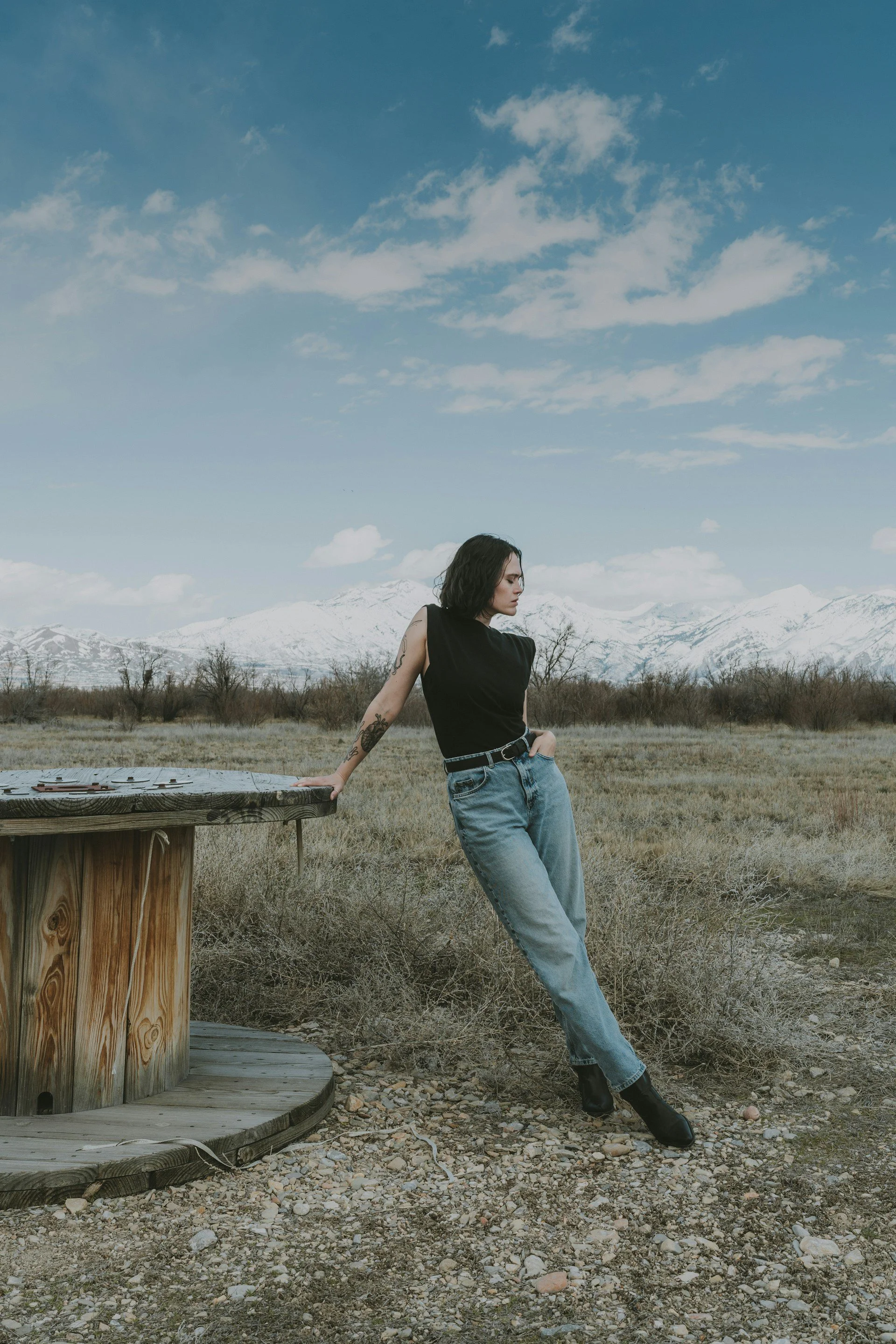 confident tattooed woman in front of wasatch mountains