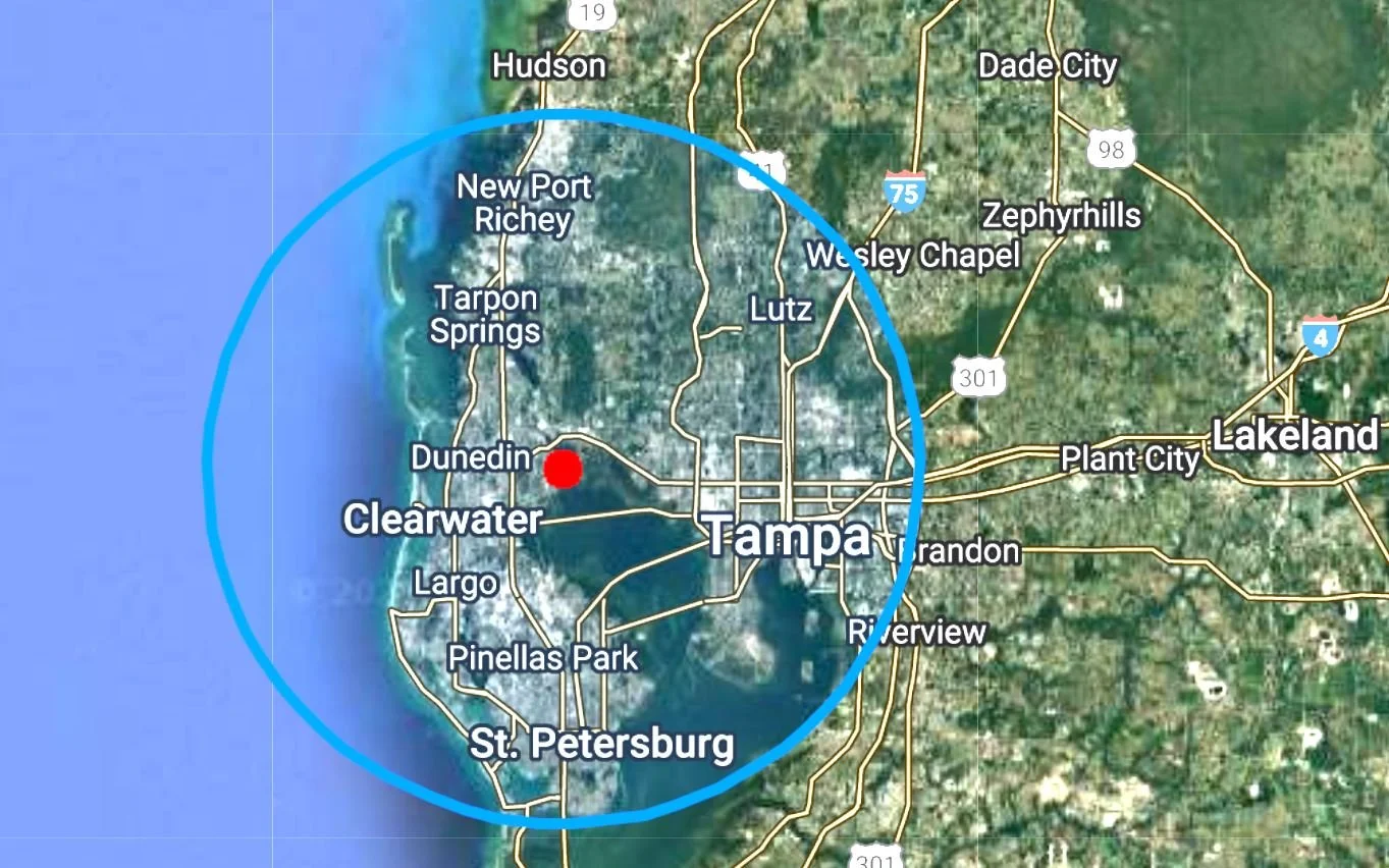 Map of Tampa, Florida, with a blue circle centered on downtown Tampa, highlighting surrounding cities including St. Petersburg, Lutz, Plant City, Thonotosassa, Ybor City, and Seminole Heights. Central Florida Real Estate Sign Post Installation
