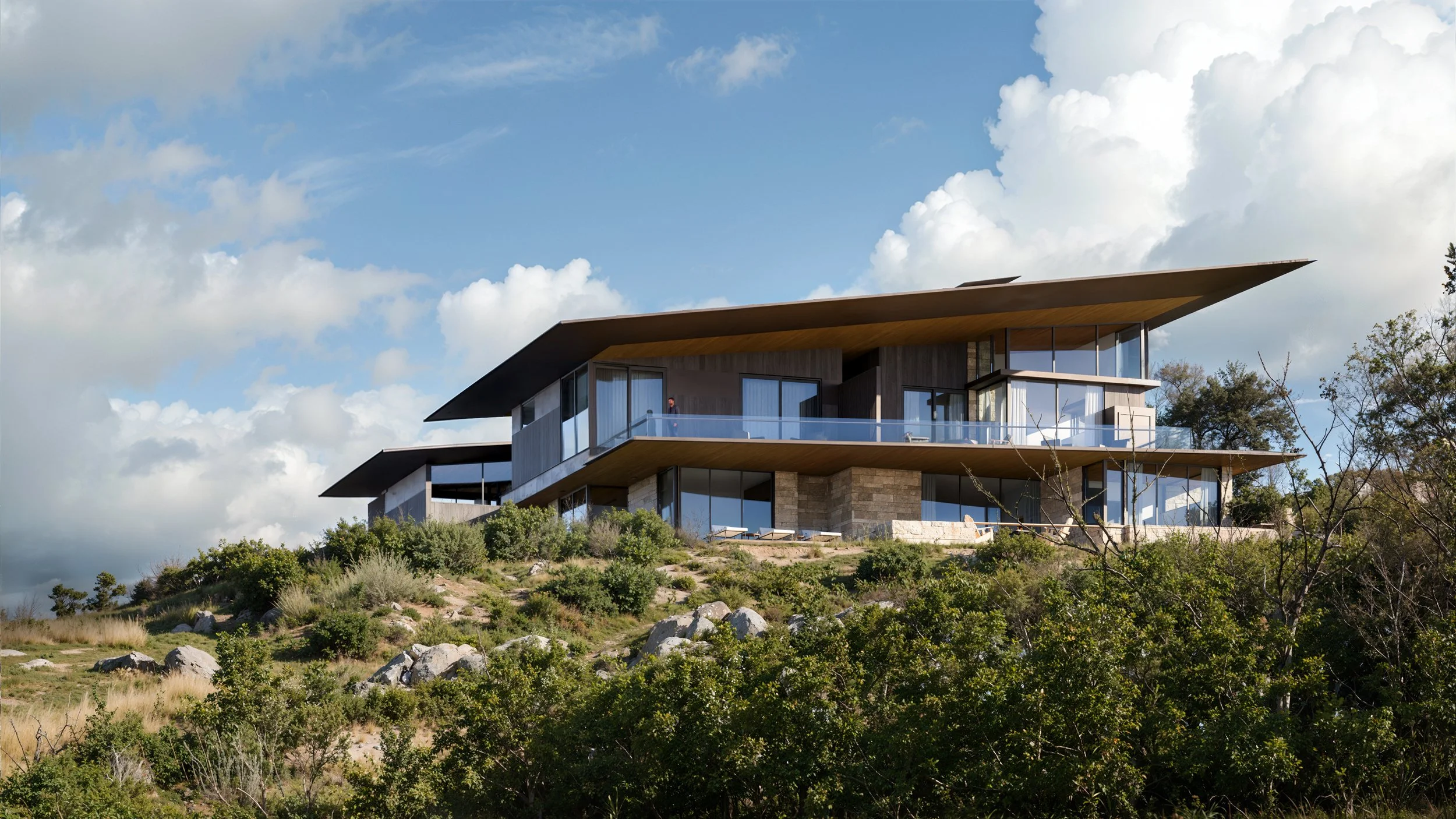 Modern multi-story house on a hillside with large glass windows, wide balconies, and a sloped roof, surrounded by greenery and a partly cloudy sky.