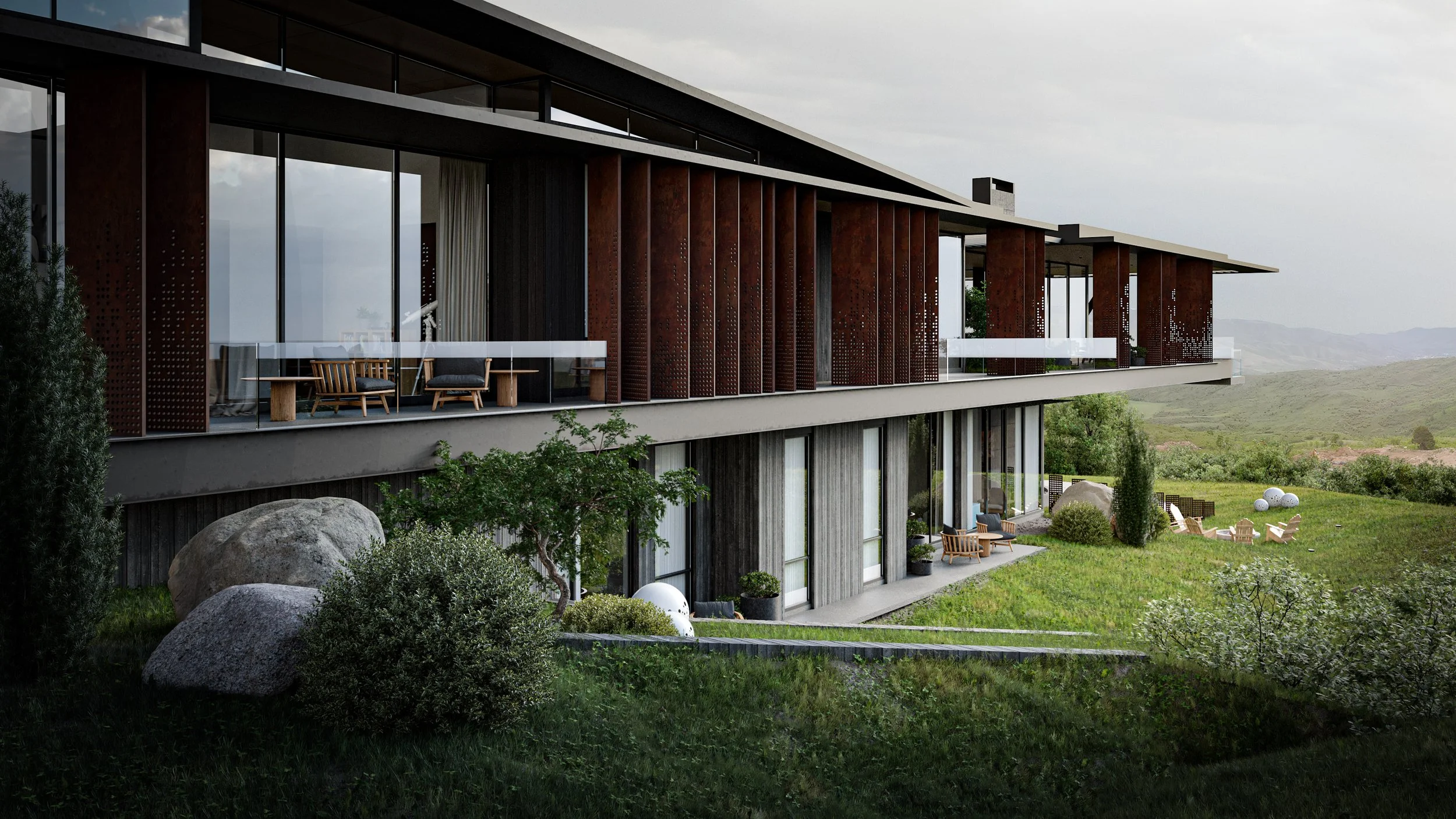 Modern multi-story house with large glass windows, wooden panel accents, and outdoor seating areas, set in a green landscape with rocks and hills in the background.