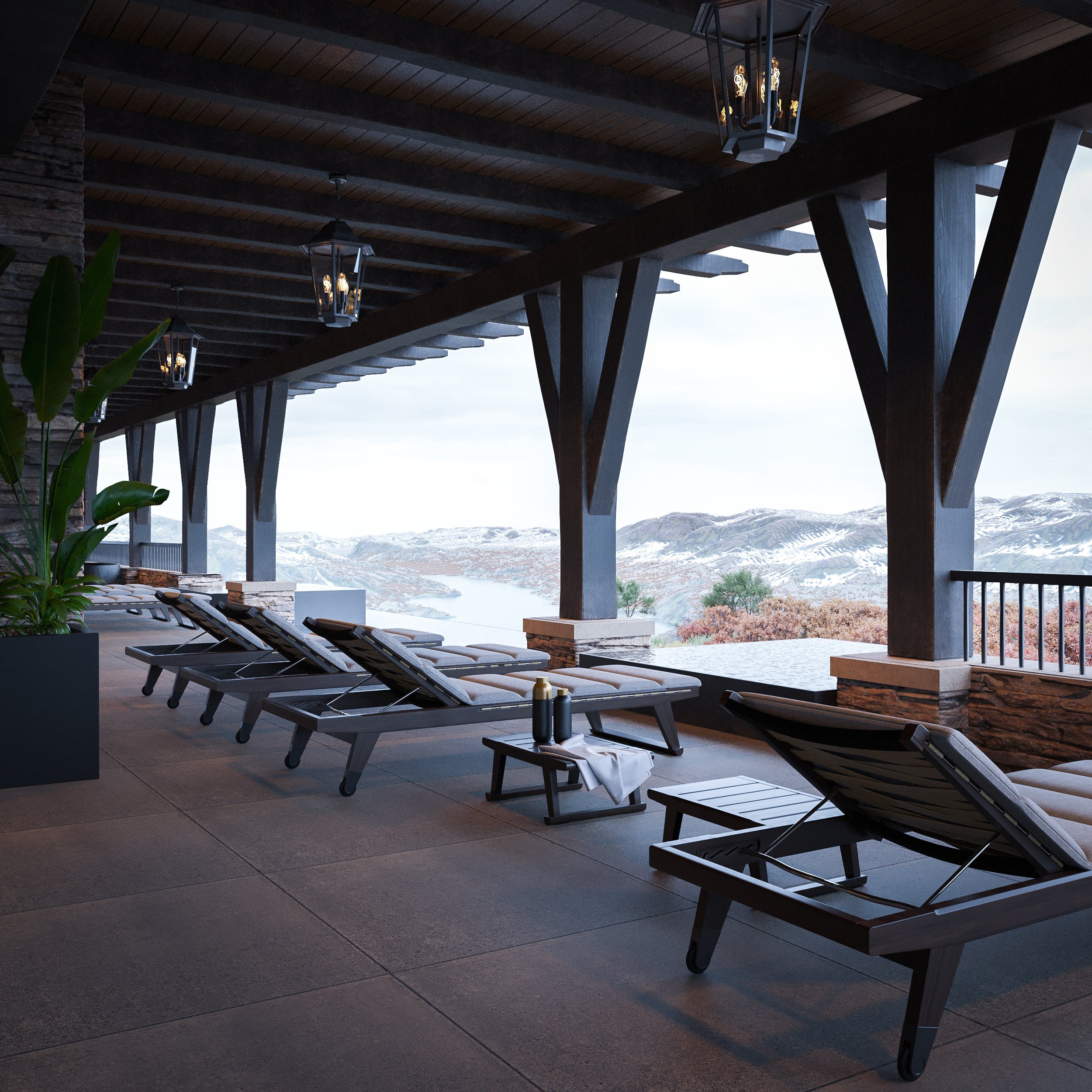 Upscale outdoor balcony with reclining lounge chairs overlooking snowy mountains and a river landscape in the distance, with modern black lantern-style light fixtures hanging from the wooden ceiling.