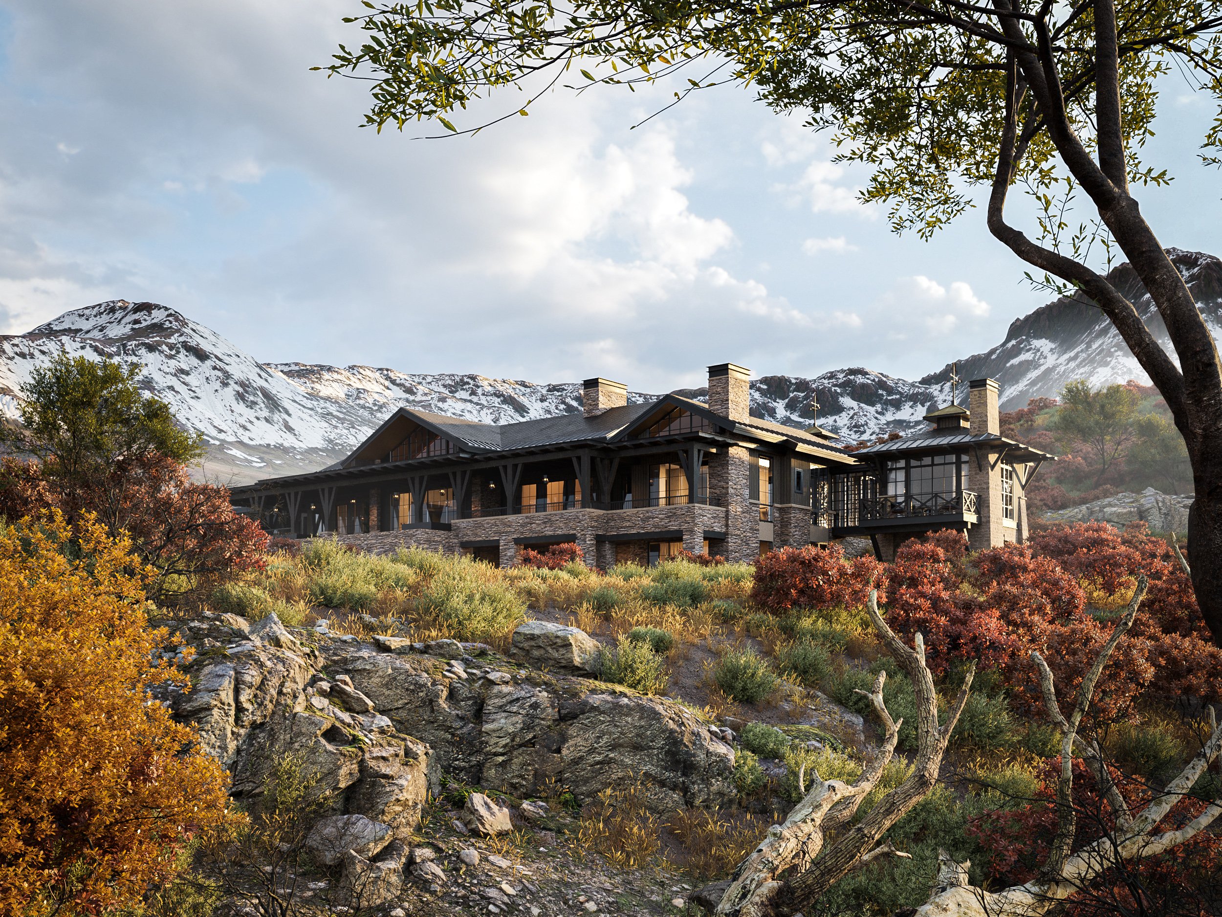 A large mountain house surrounded by autumn trees and rocky terrain, with snow-capped mountains in the background under a partly cloudy sky.