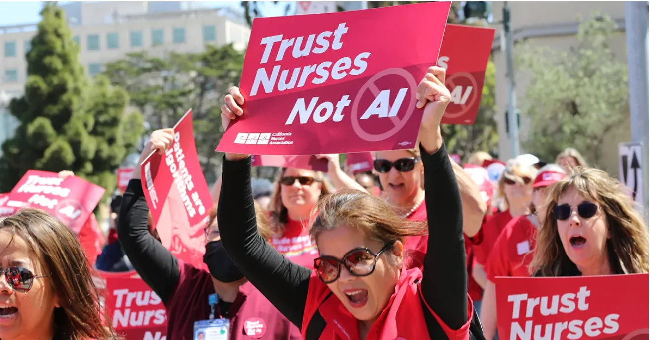 Nurses protesting, with banners reading "Trust Nurses Not AI"