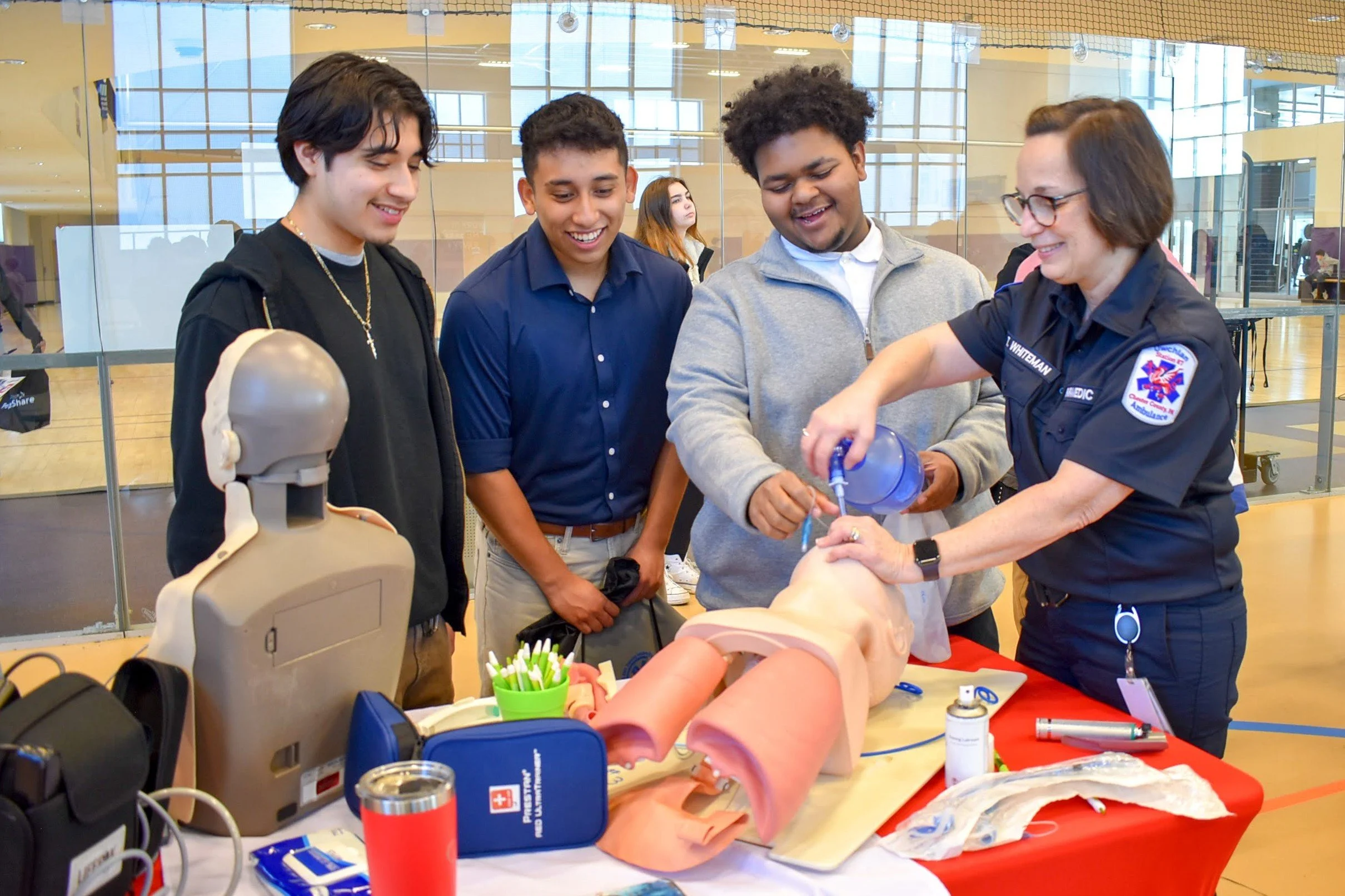 CCF Career Expo exhibitor engages with 3 students.