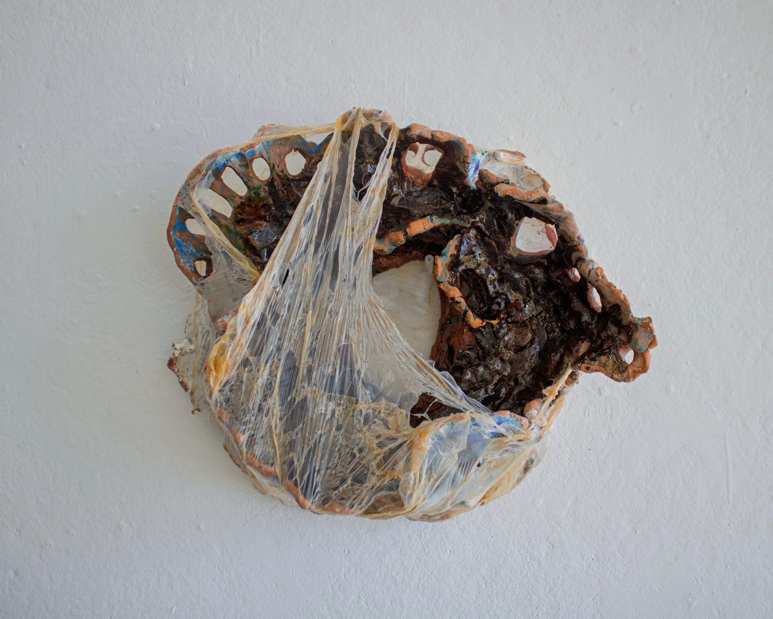 Unfolding from Ruin (Emerging), 2026. Low-fire ceramics, glaze, latex on plastic. 7 x 15 x 13.5 inches.