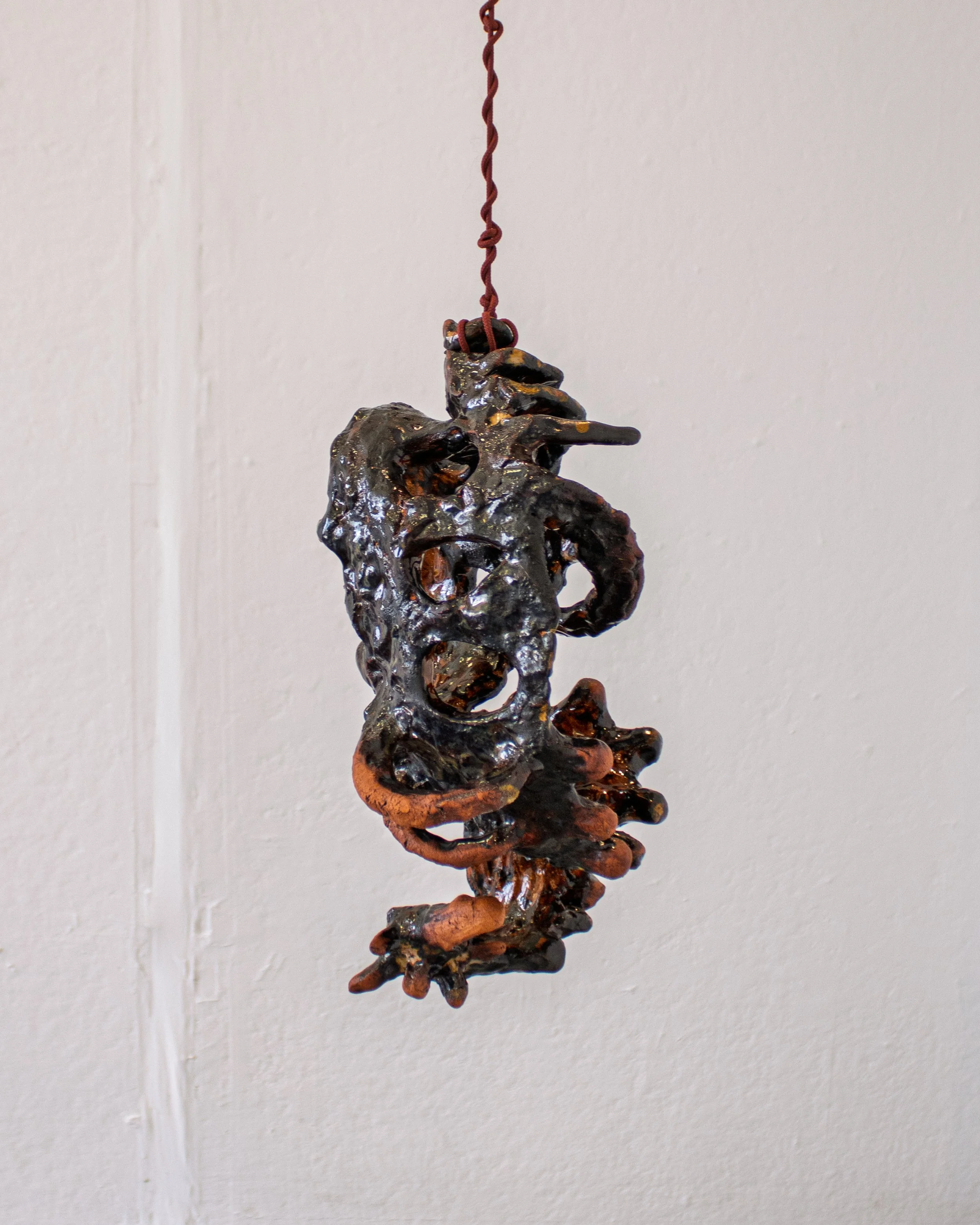 Twisted Empty (Suspended), 2026. Low-fire ceramics and glaze. 14.5 x 8 x 7 icnhes.