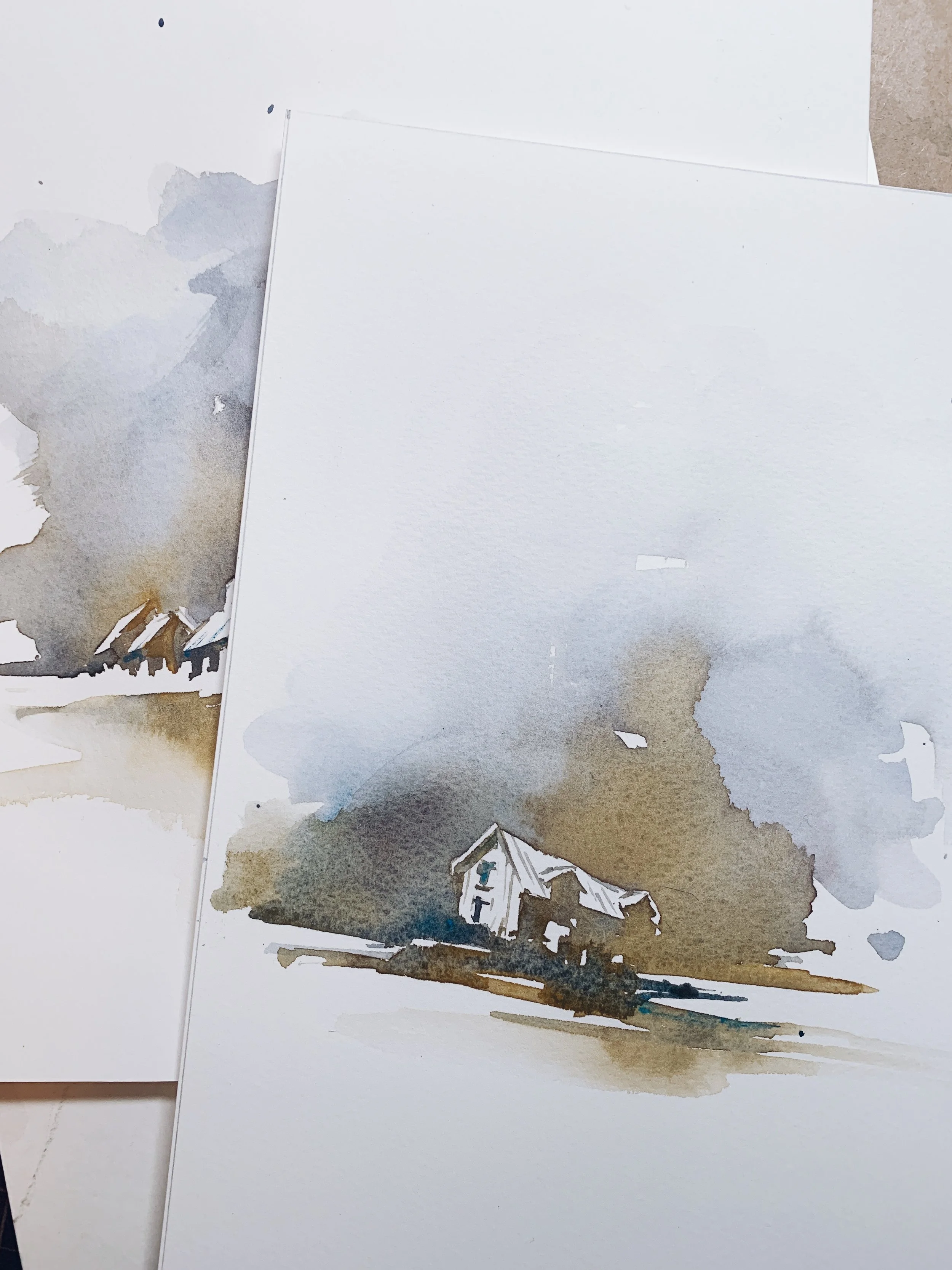 Watercolor painting of a small, abandoned barn with dark clouds in the background.