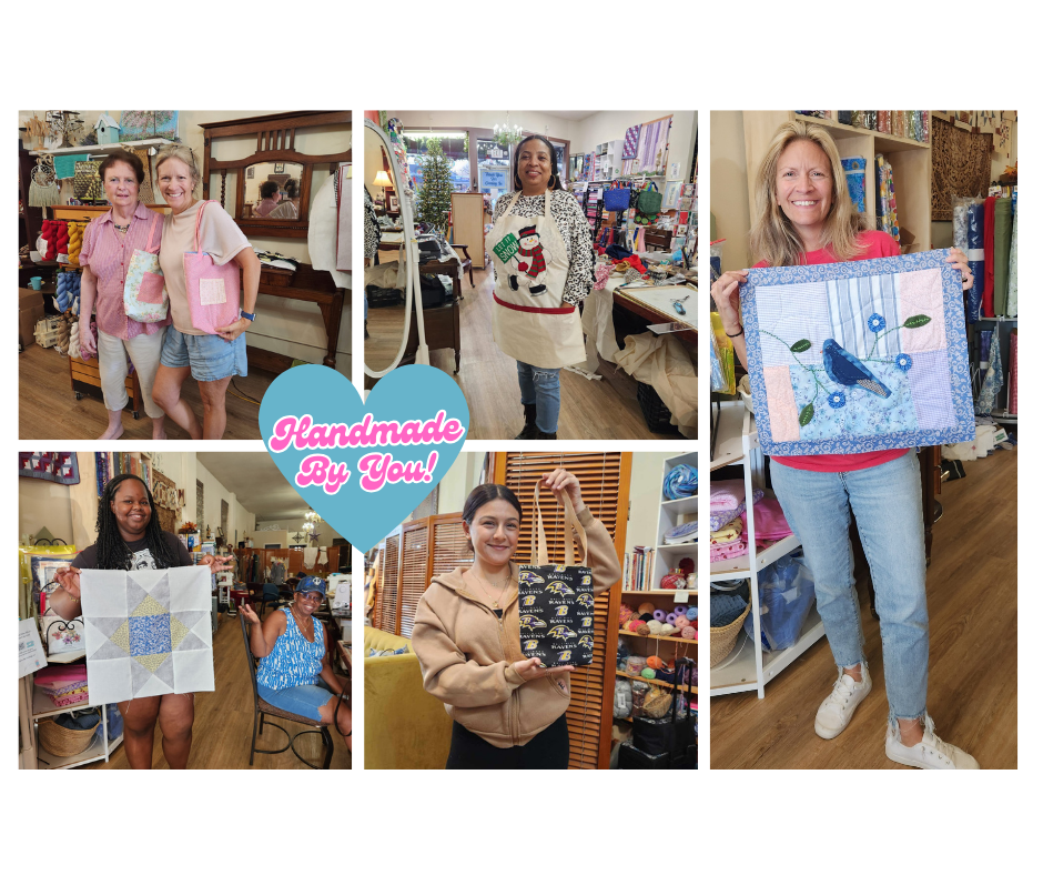 Women selling handmade crafts at a craft fair, displaying quilts, wall hangings, and fabric items in a cozy store setting.
