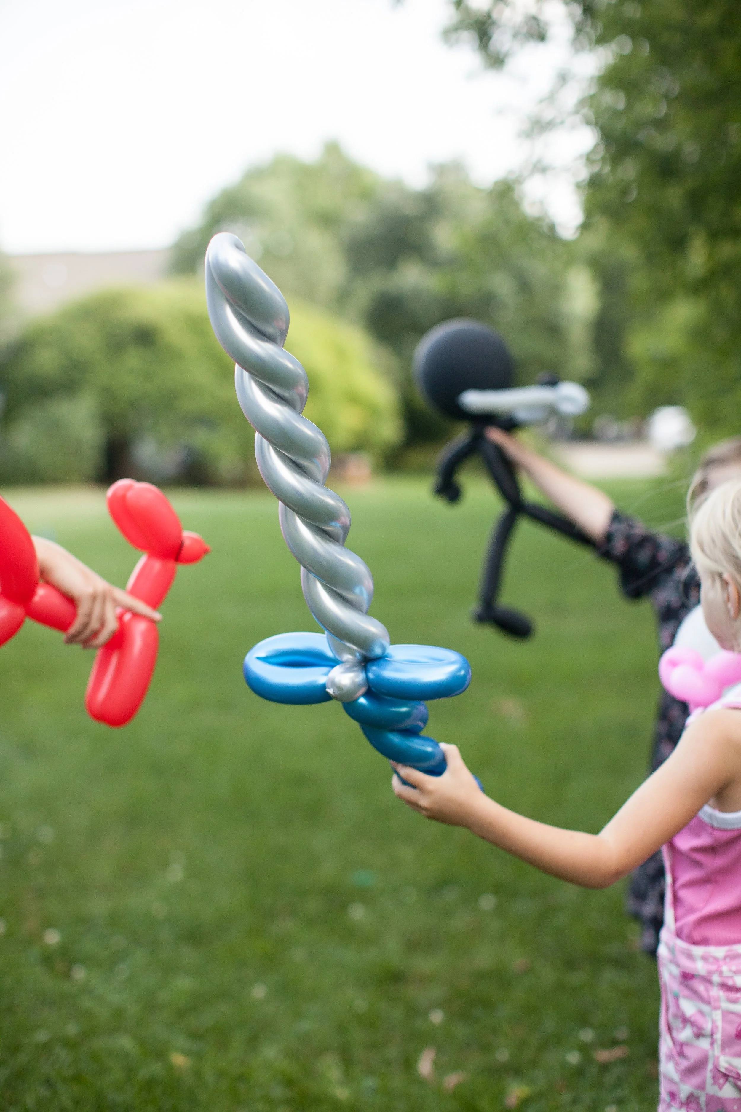 kids playing with balloon twisted creations