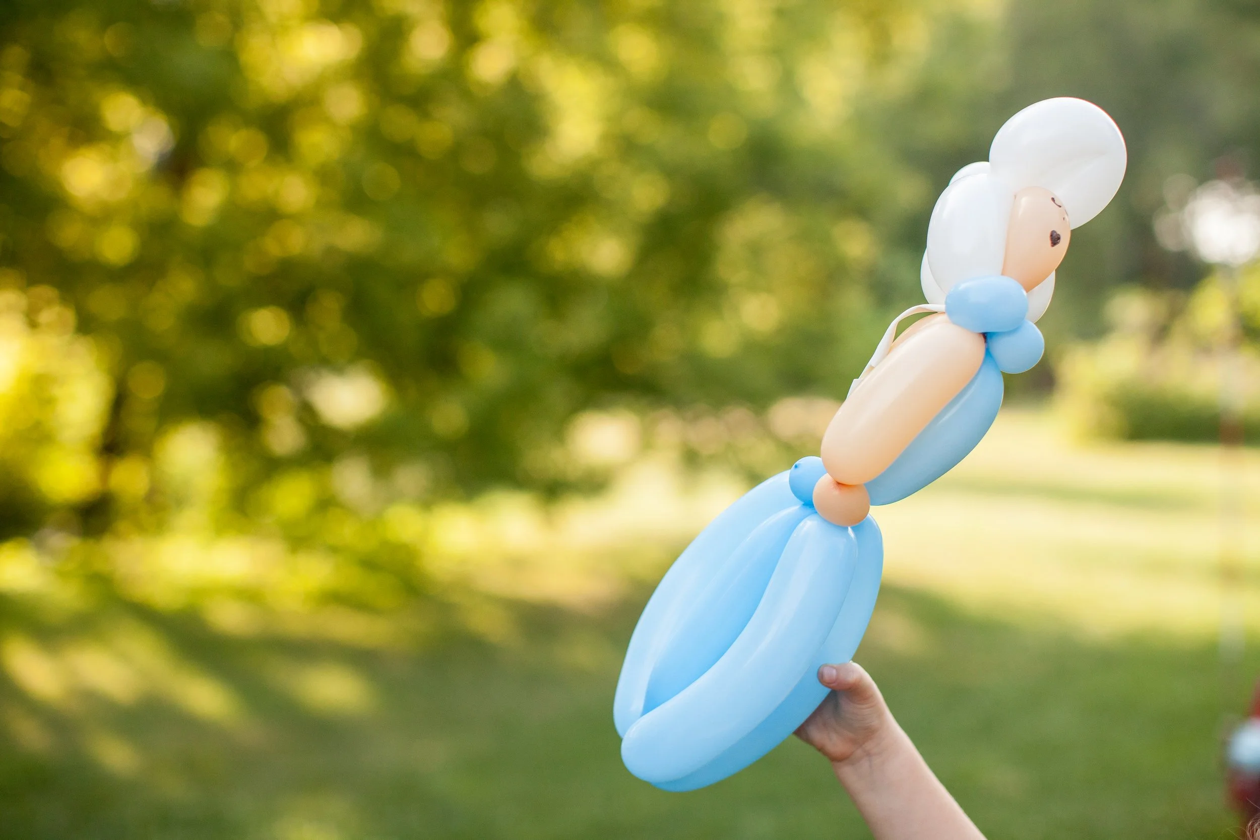 child playing with twisted balloon winter princess elsa frozen