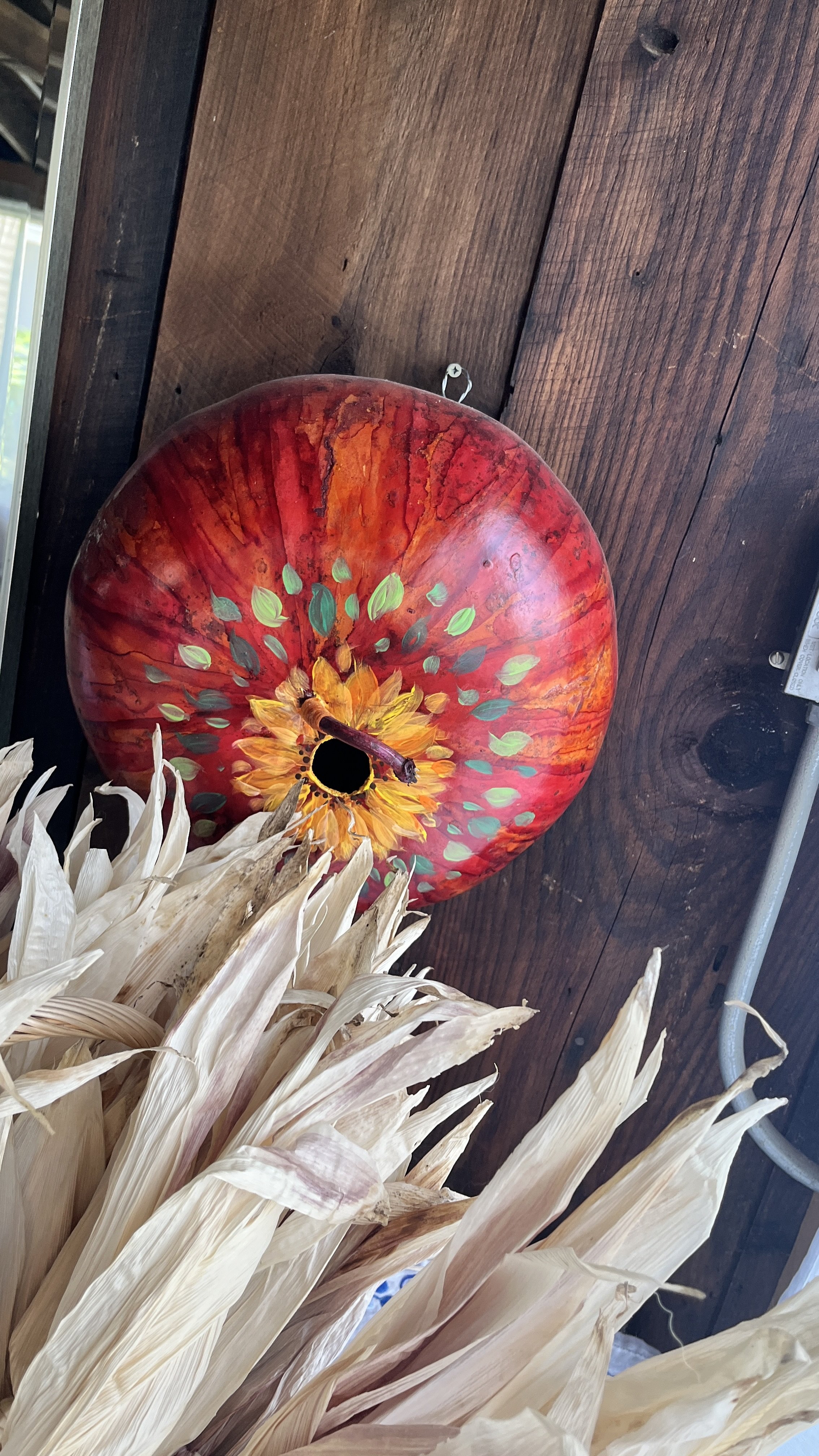 large gourd painted, with perch for the birdies 
