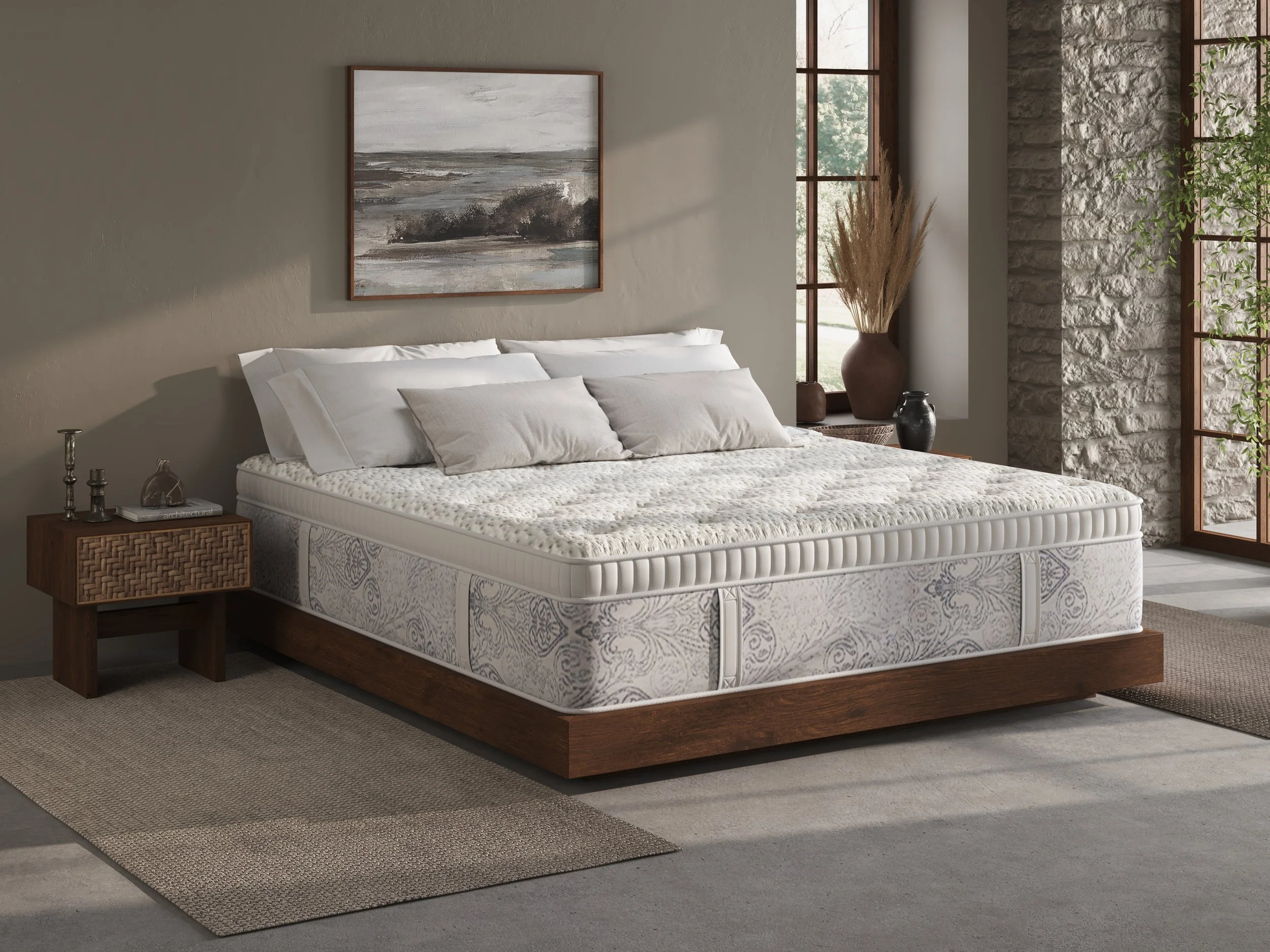 A bedroom with a wooden bed frame, a white mattress, multiple white and beige pillows, a wooden nightstand with decor, large windows with natural light, potted plants, and a wall art painting above the bed.