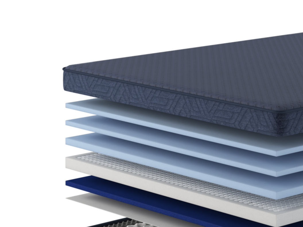 Close-up of a layered mattress with fabric, foam, and support materials.